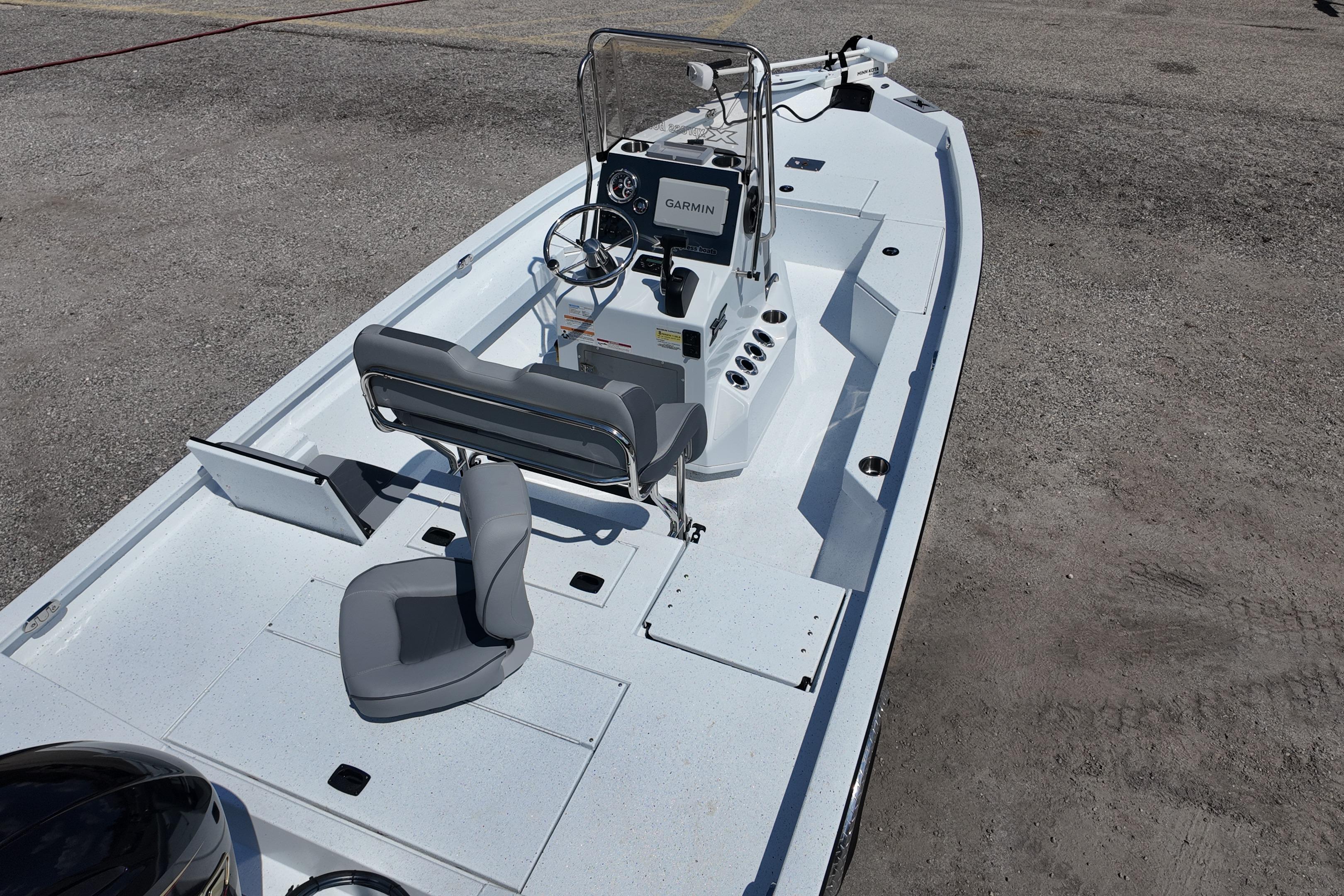 2026 Xpress H20 boat with modern seating and navigation system on a concrete surface.
