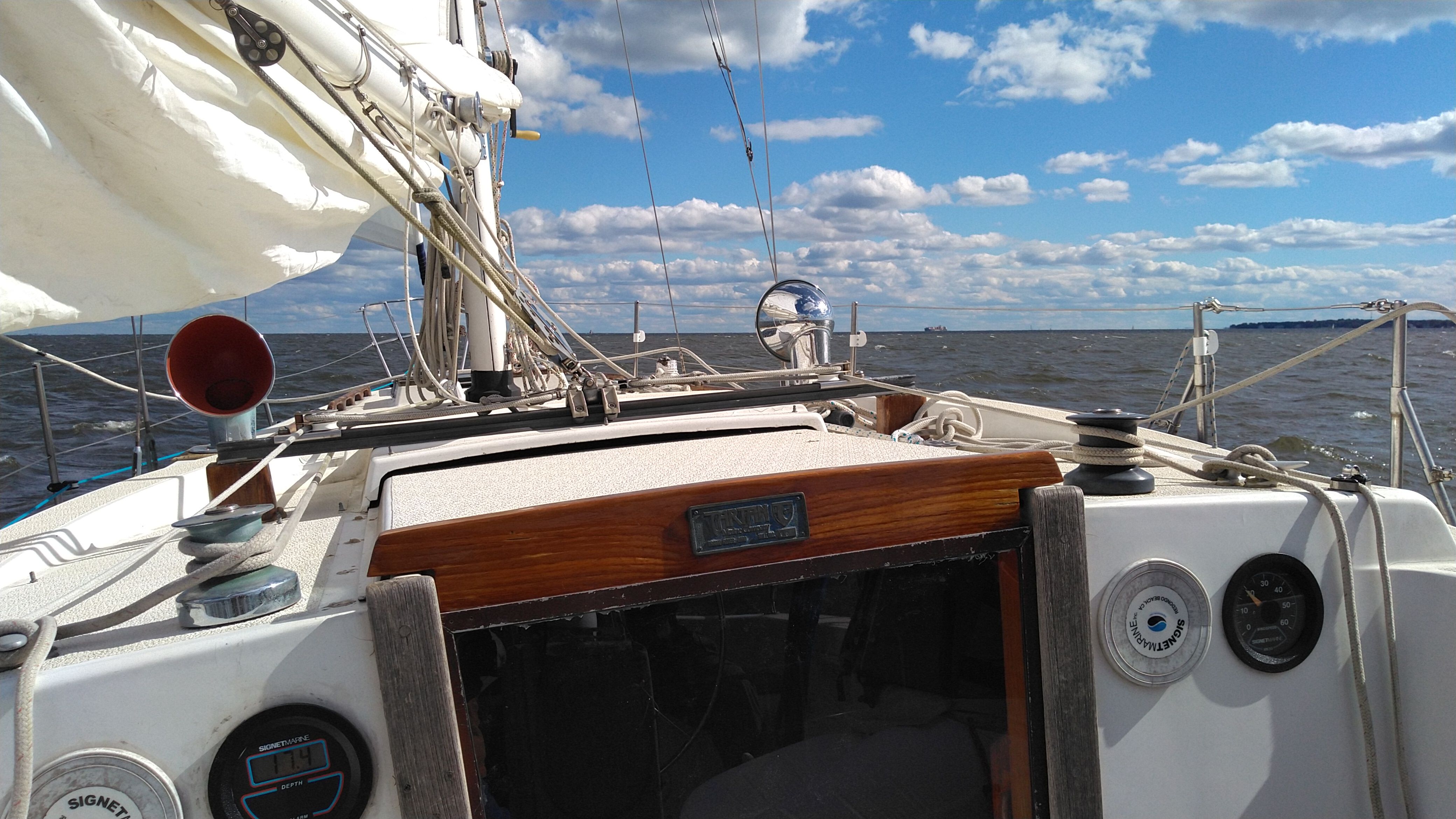 1978 Tartan 37 sailboat on open water under a blue sky.
