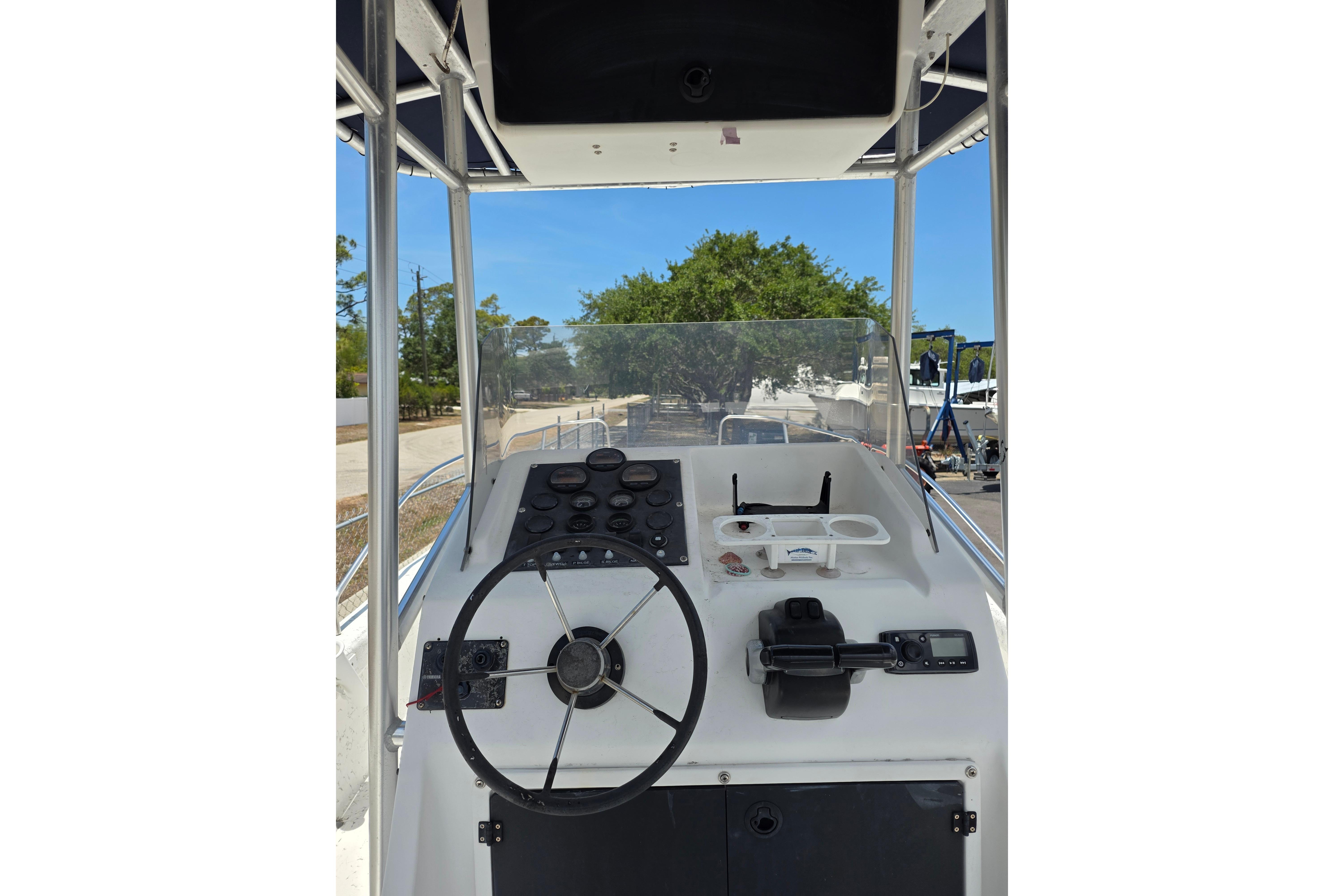 1999 Twin Vee Awesome 22 boat dashboard with steering wheel and controls.