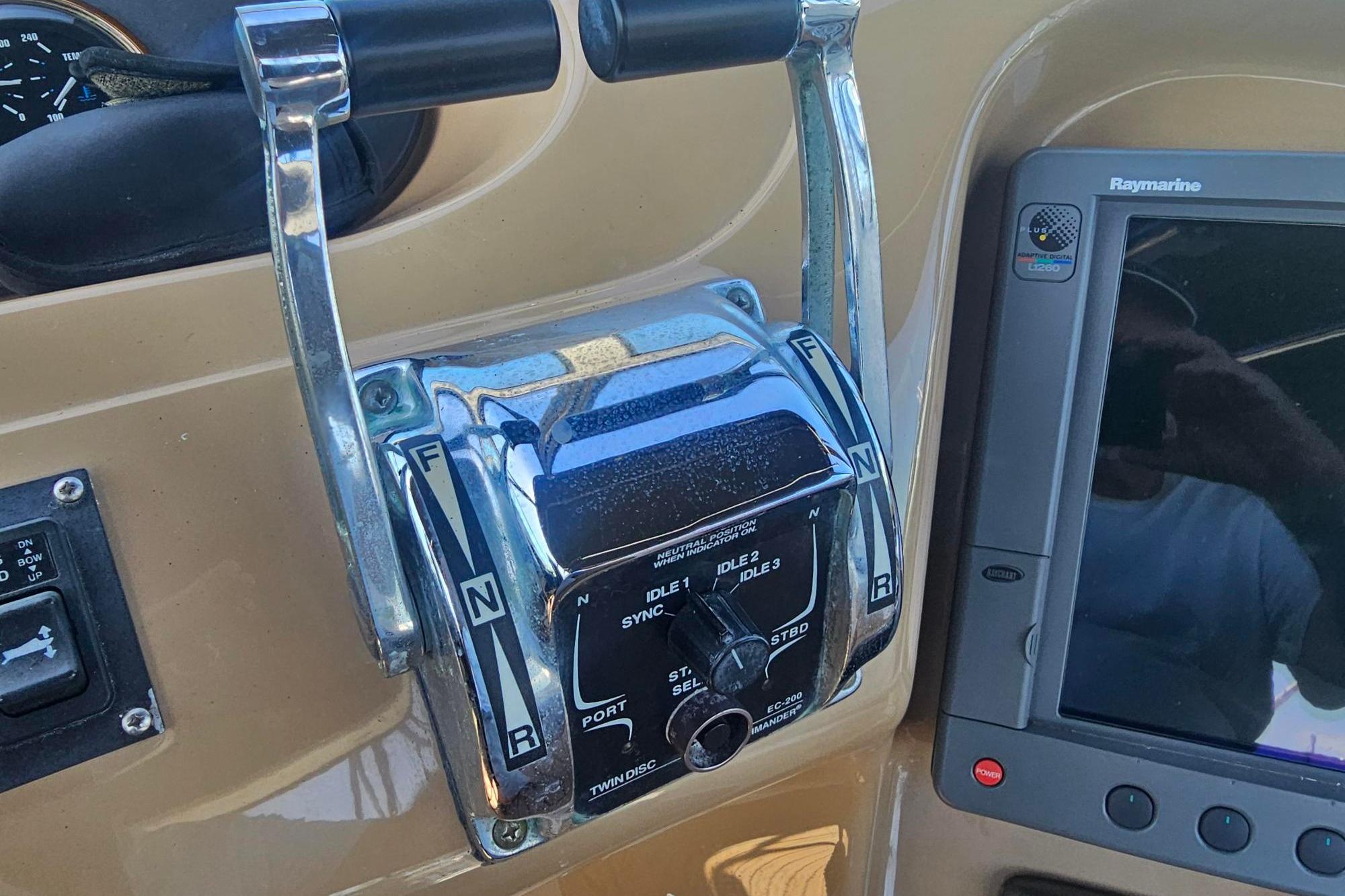 Close-up of 2002 Carver 450 Voyager Pilothouse throttle controls and navigation display.