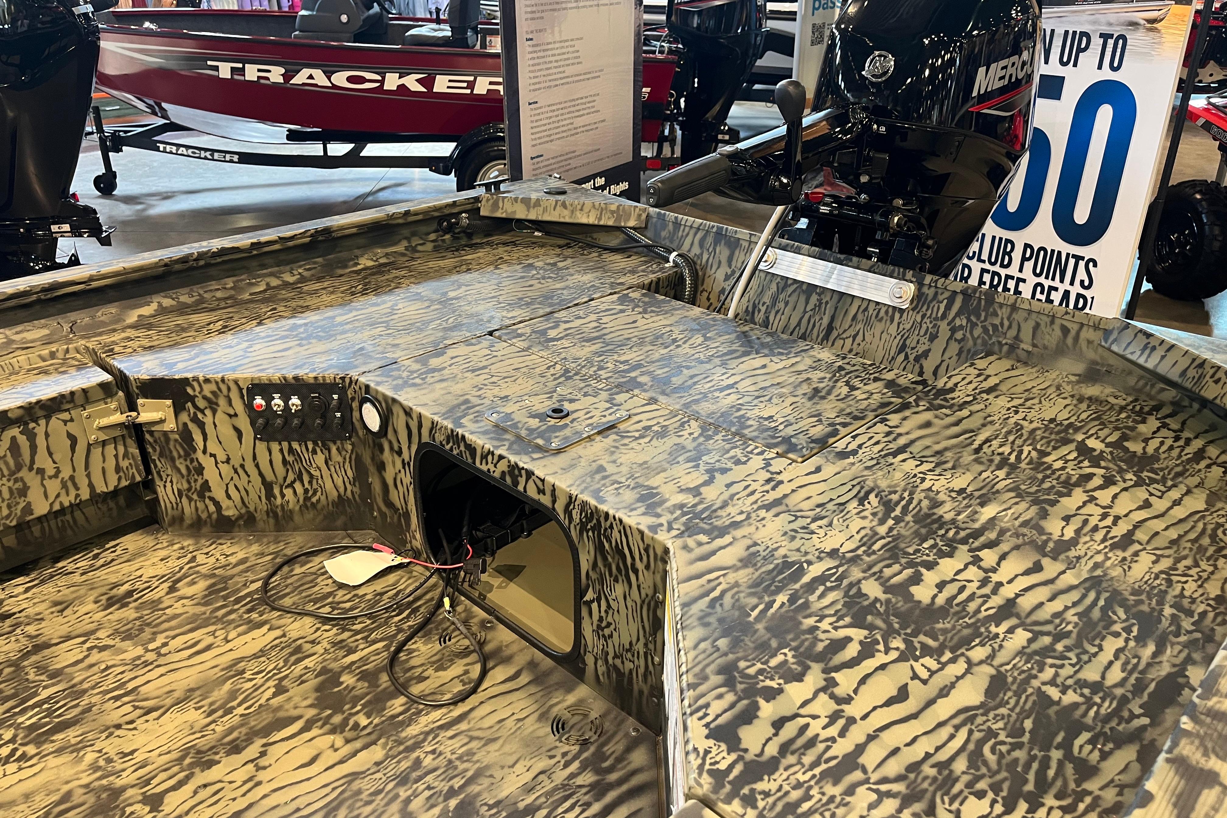 2026 Tracker Grizzly 1654 T Sportsman boat interior with camouflage design and motor.