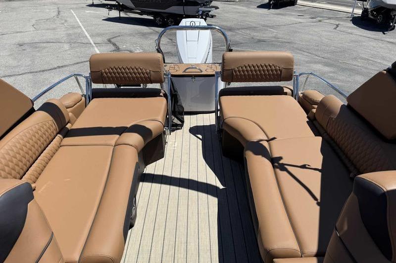Luxurious 2026 Avalon Excalibur LTD Quad Lounge boat with tan seating and sleek design.