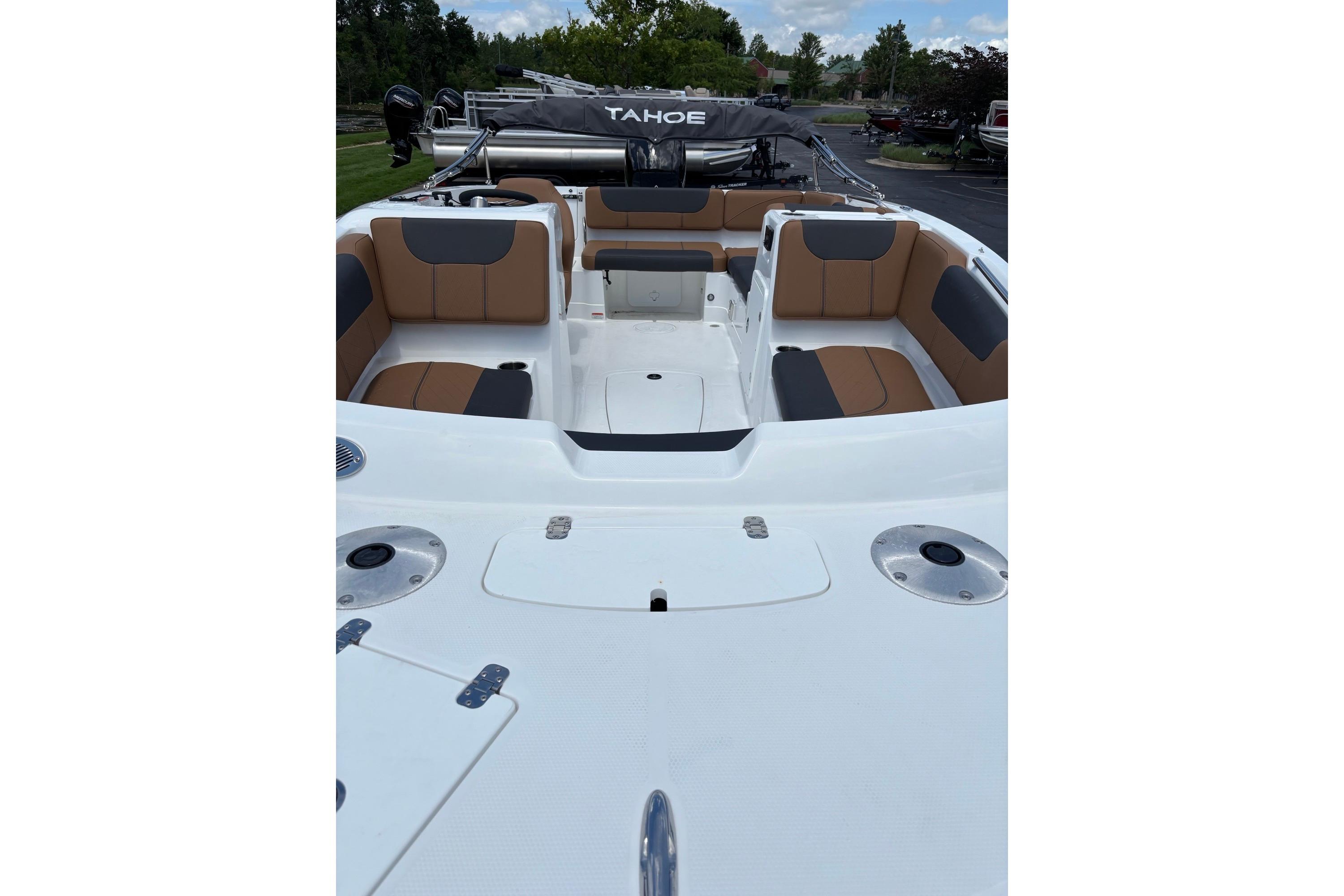 2026 Tahoe 1950 boat interior with tan and gray seating, docked outdoors.