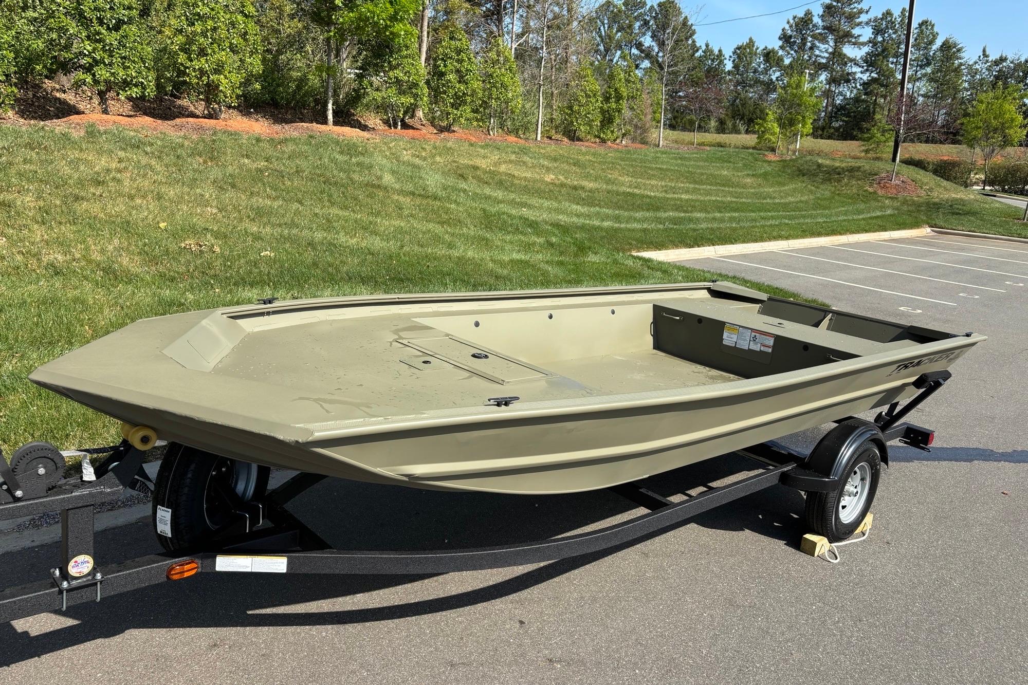 2026 Tracker Grizzly 1754 Utility boat on trailer, parked outdoors in a sunny setting.