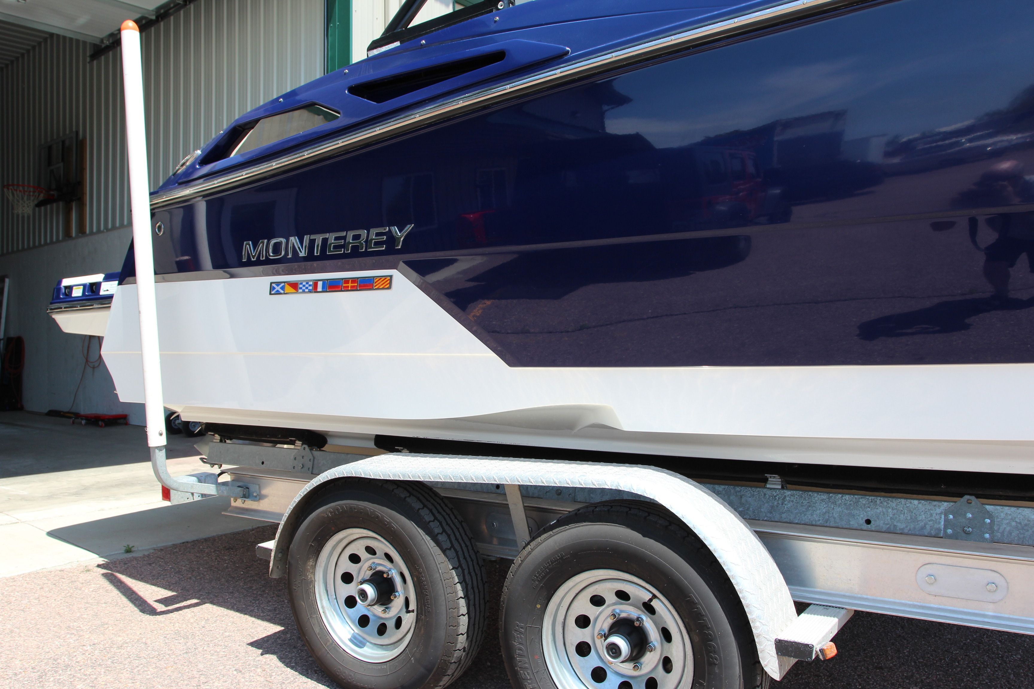 2015 Monterey 268SSC boat on trailer in garage.