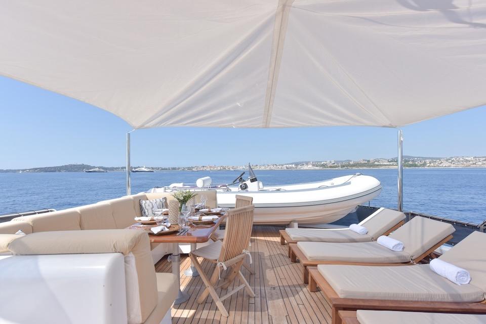 Luxurious yacht deck with dining area and sun loungers, W.A. Souter & Sons 1984 model.