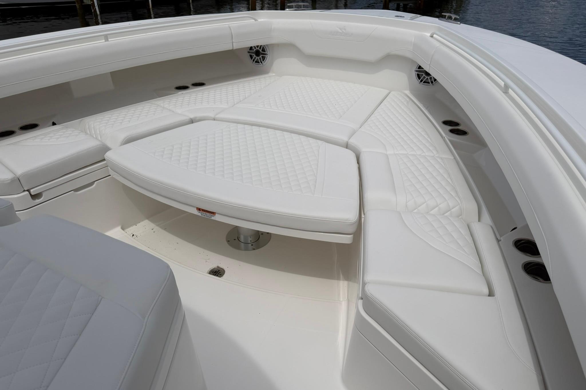 Luxurious seating area on a 2026 Regulator 37 boat, featuring white quilted upholstery.