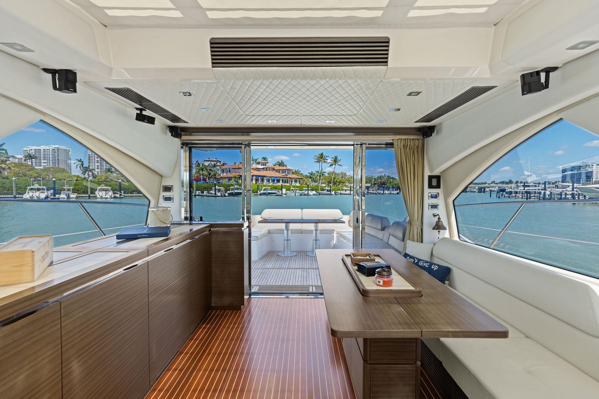 Luxurious interior of 2015 Azimut 55S yacht with waterfront view and elegant furnishings.