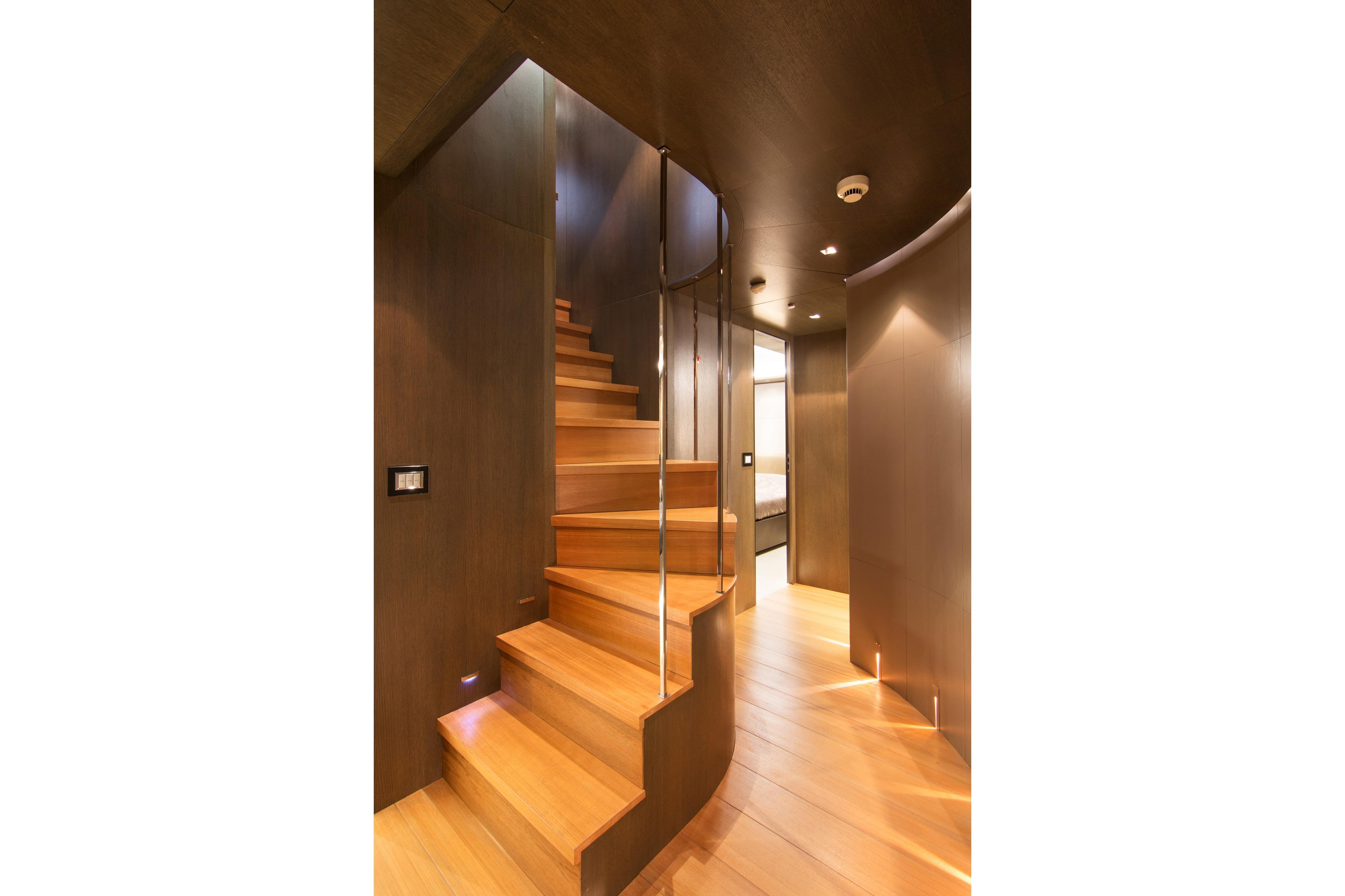 Luxurious wooden staircase in 2009 Admiral yacht interior.