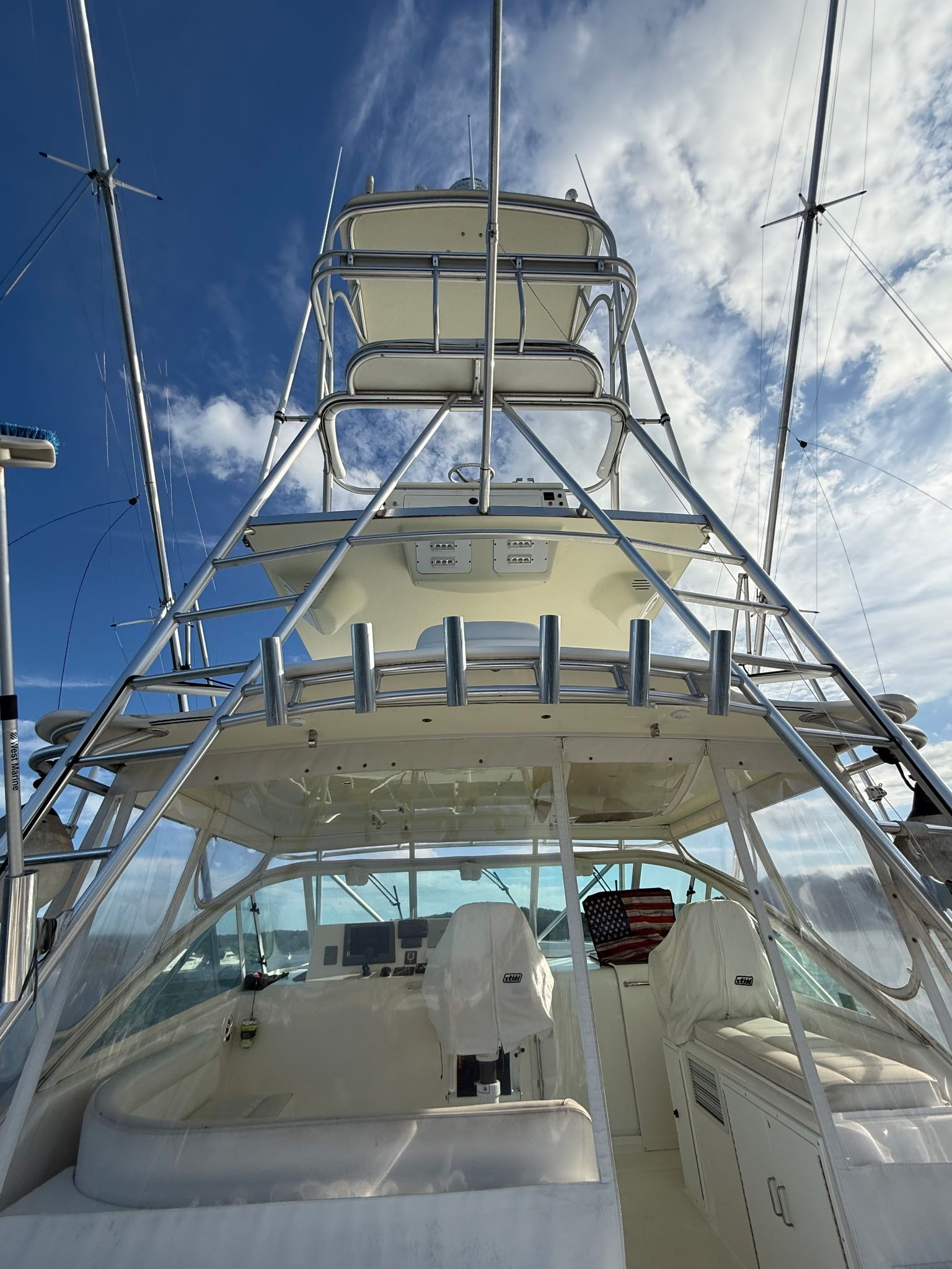 A 2005 Cabo Express with a tall helm station and multiple fishing rod holders.