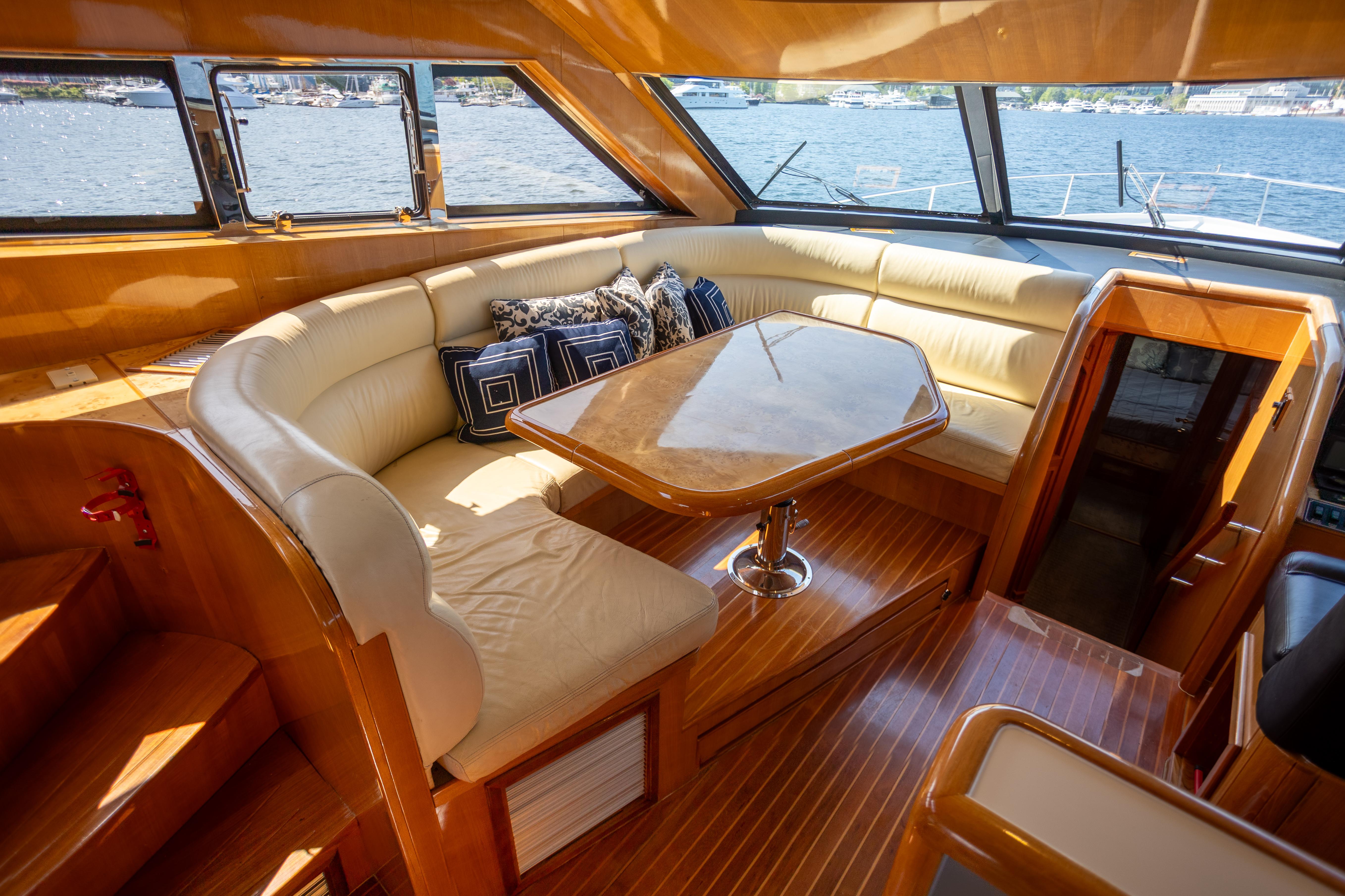 Luxurious interior of a 2001 Vitech 72 yacht with plush seating and elegant wood finishes.