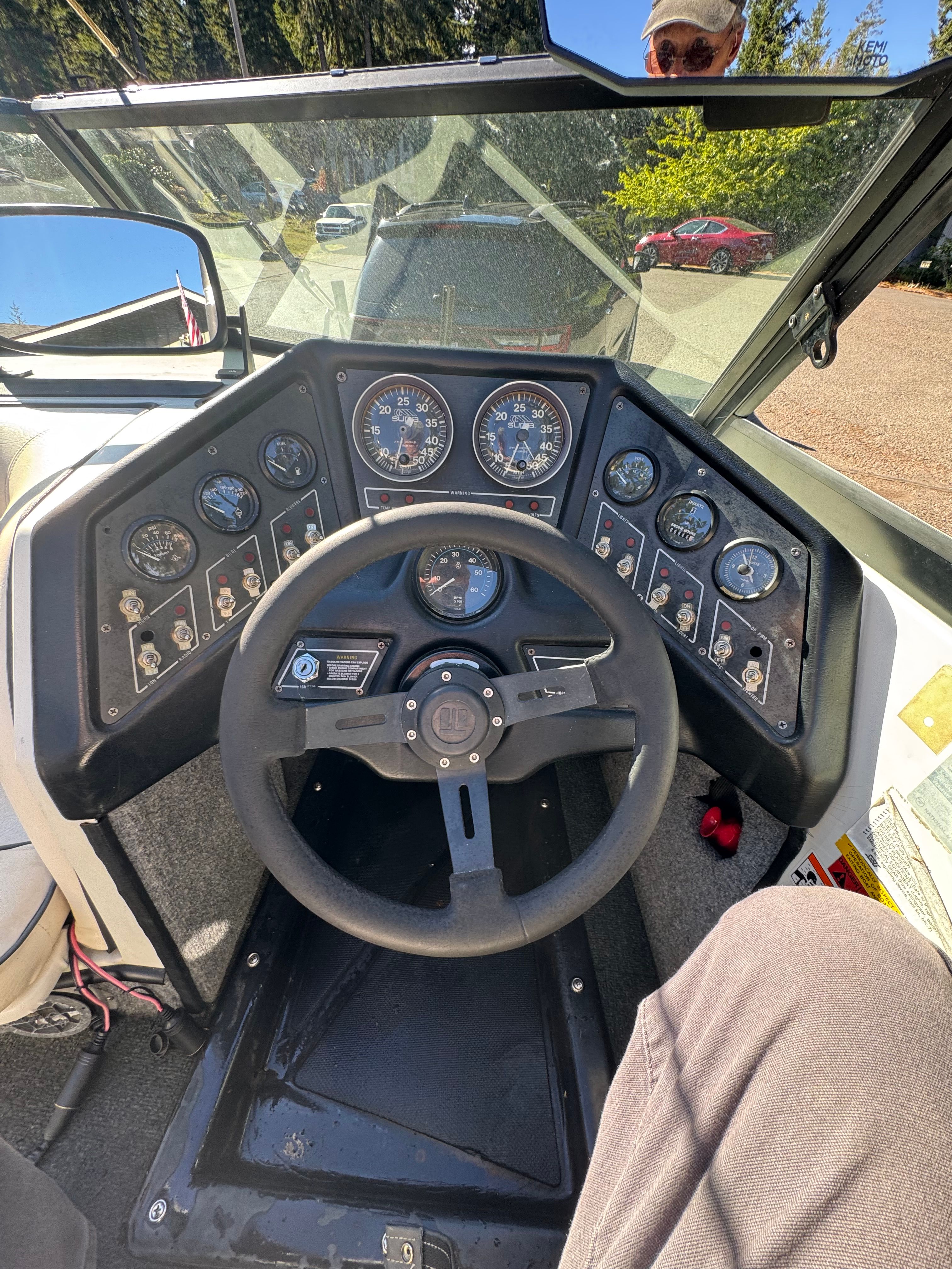 Dashboard of a 1990 Supra TS6M boat with steering wheel and gauges.