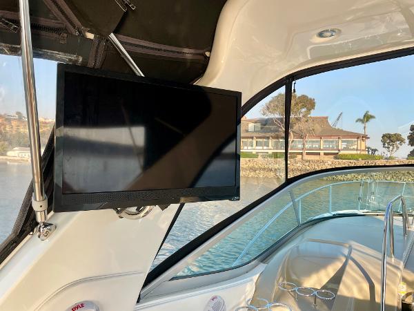 2014 Sea Ray 330 Sundancer interior with mounted TV and scenic water view.