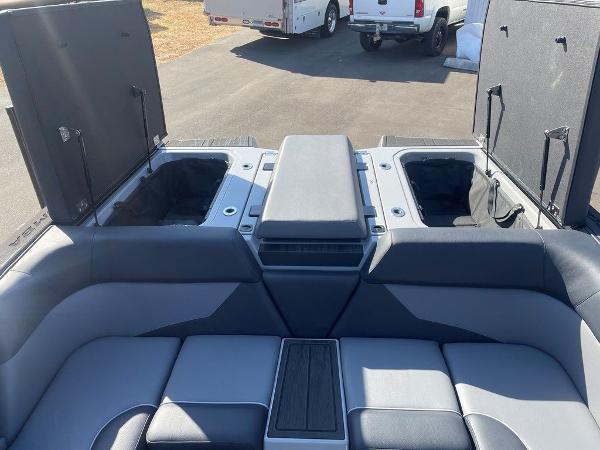 2025 Moomba Mondo boat interior with open storage compartments and cushioned seating.
