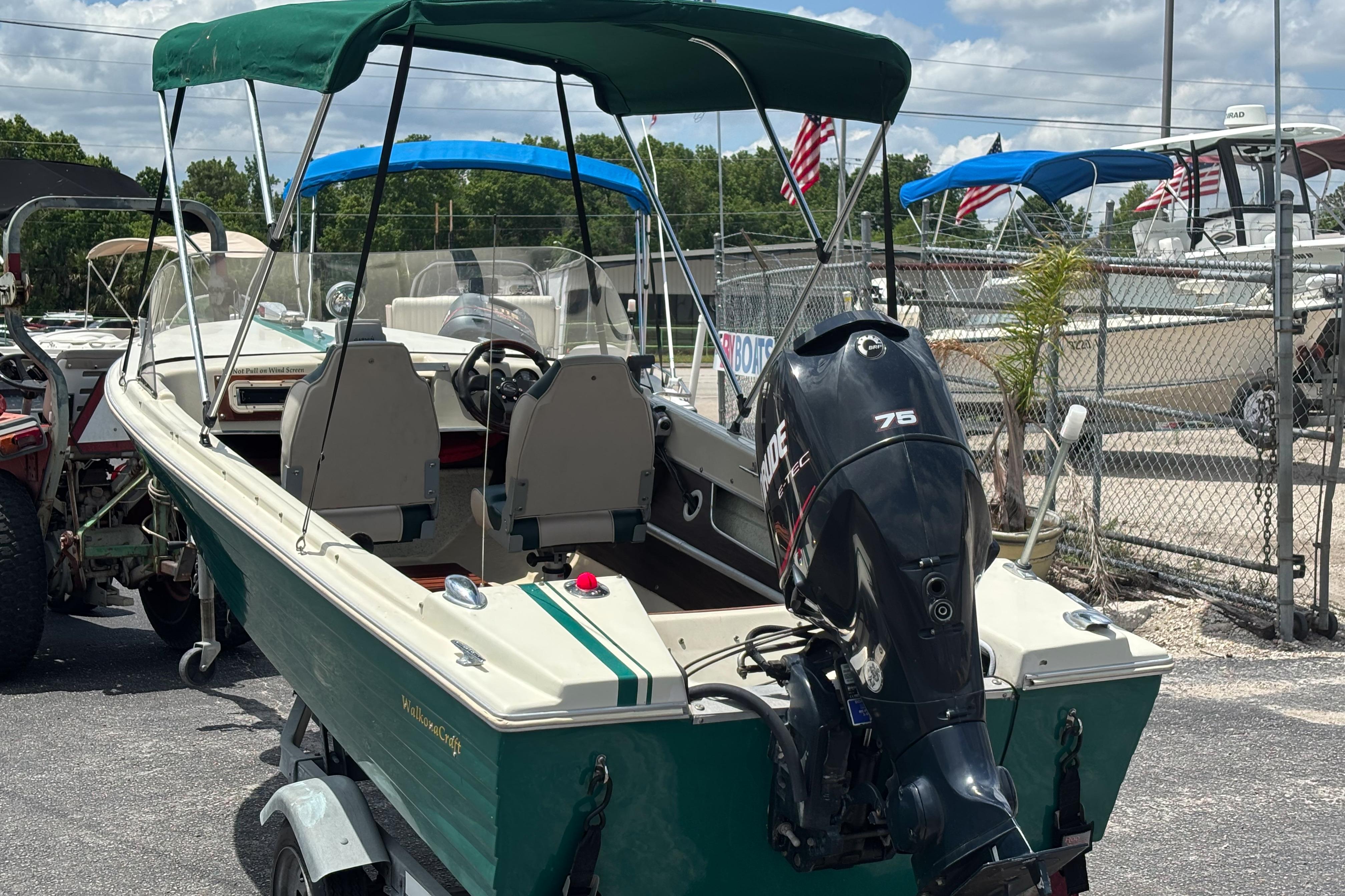 1966 Mohawk 15 boat with canopy and outboard motor in a marina setting.