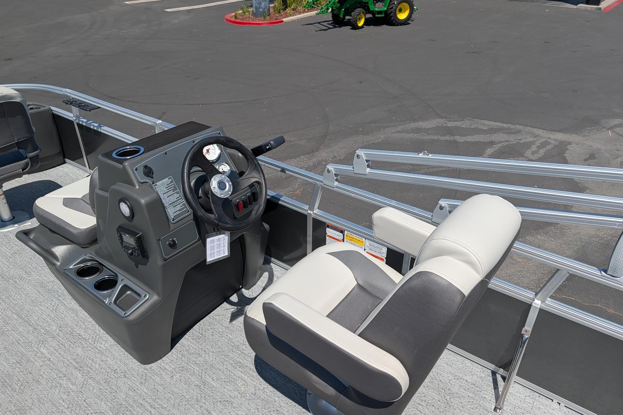 2026 Sun Tracker Bass Buggy 18 DLX pontoon boat interior with steering console and seating.