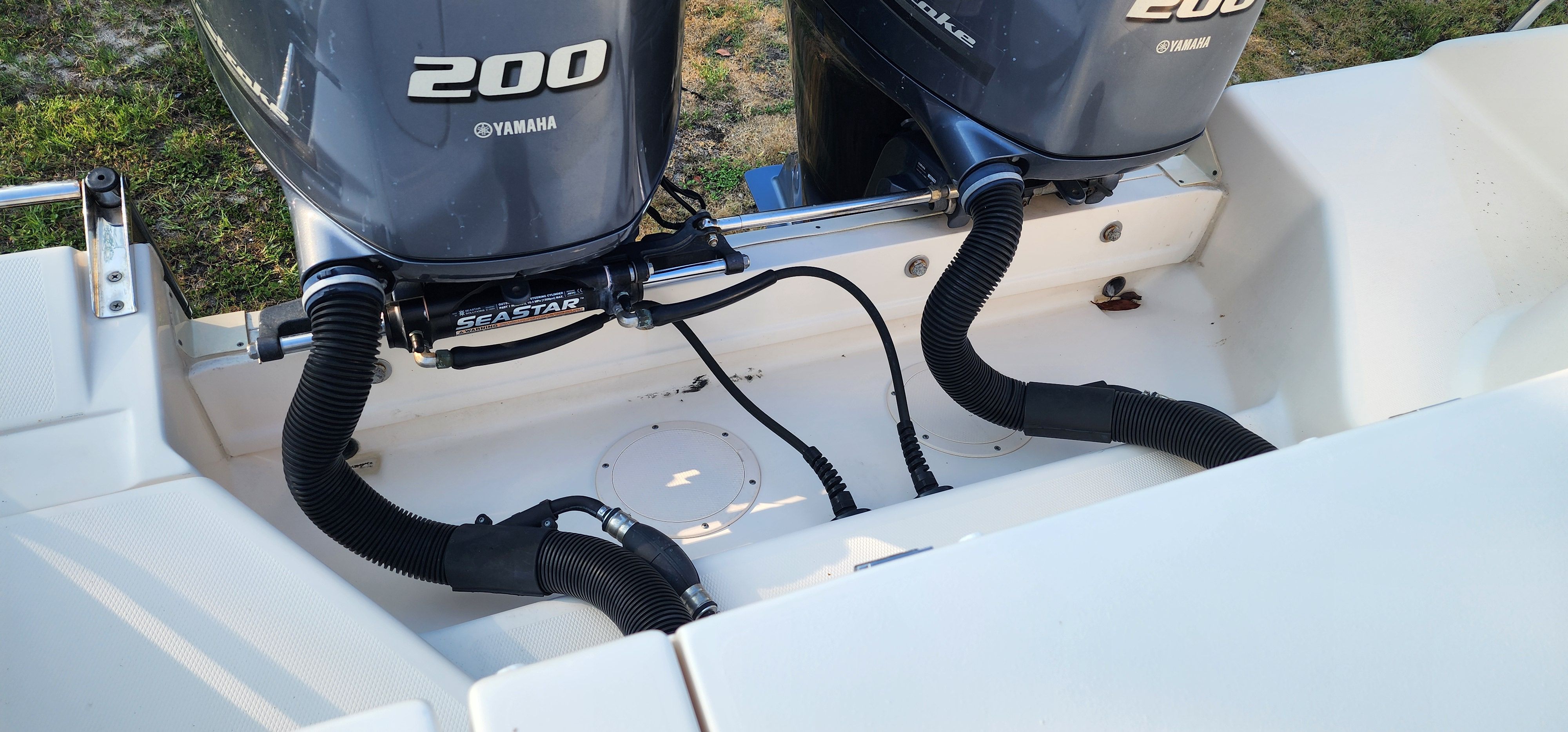 Two Yamaha 200 outboard engines are mounted on the stern of a Grady-White Freedom 275 boat.