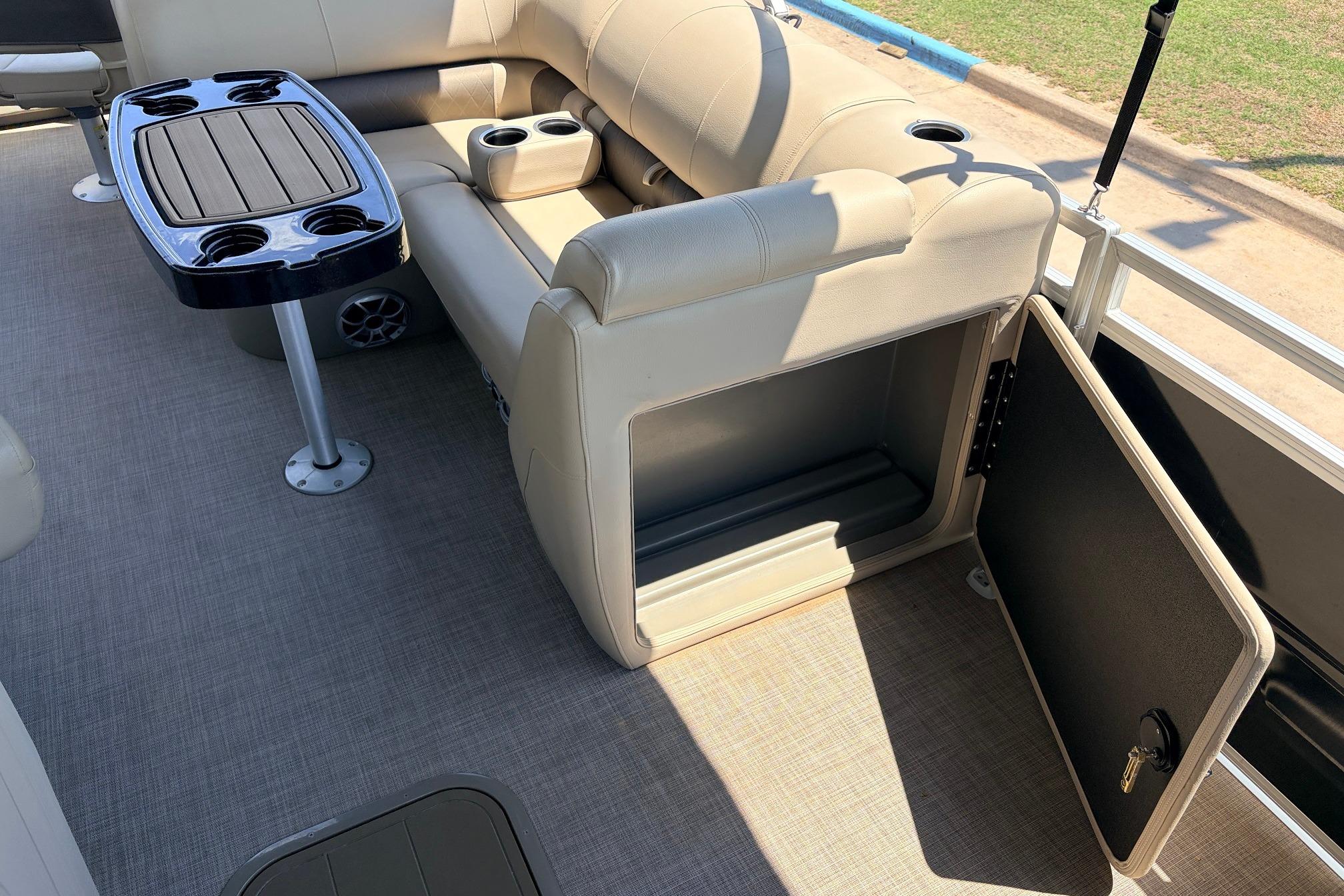 2024 Sun Tracker SportFish 22 XP3 interior with seating, storage, and cupholders.