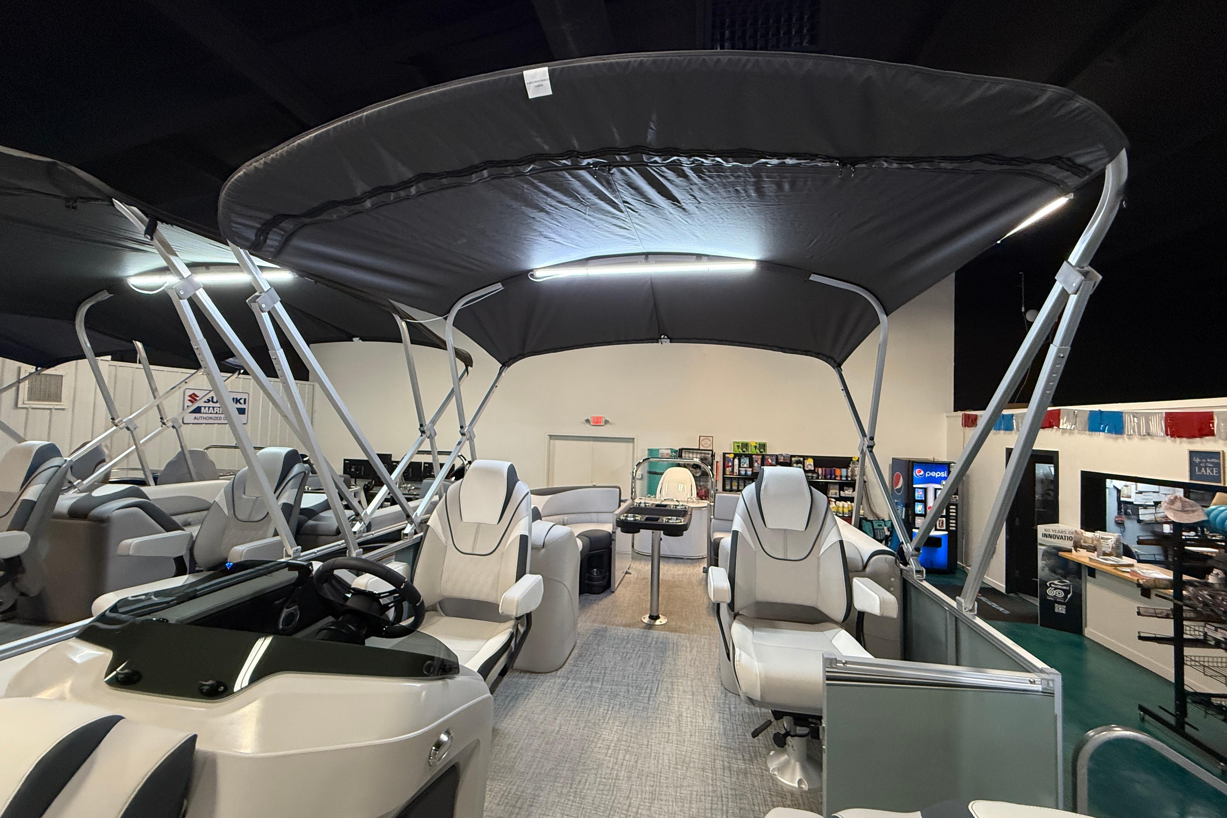 2026 Tahoe Pontoon LTZ Quad Lounger with canopy, showcased indoors.