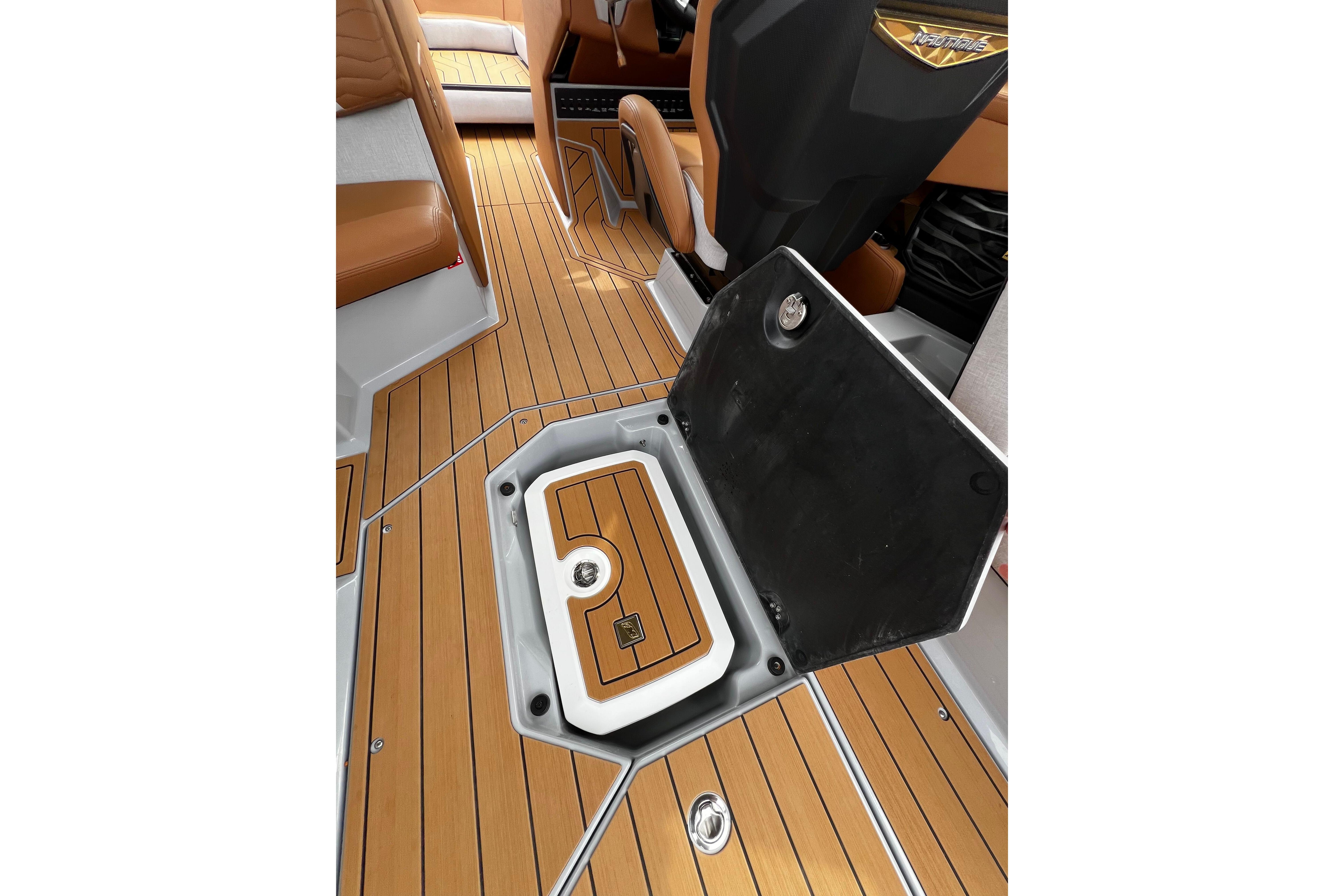 2026 Nautique Super Air Nautique G25 interior with teak flooring and storage compartment.