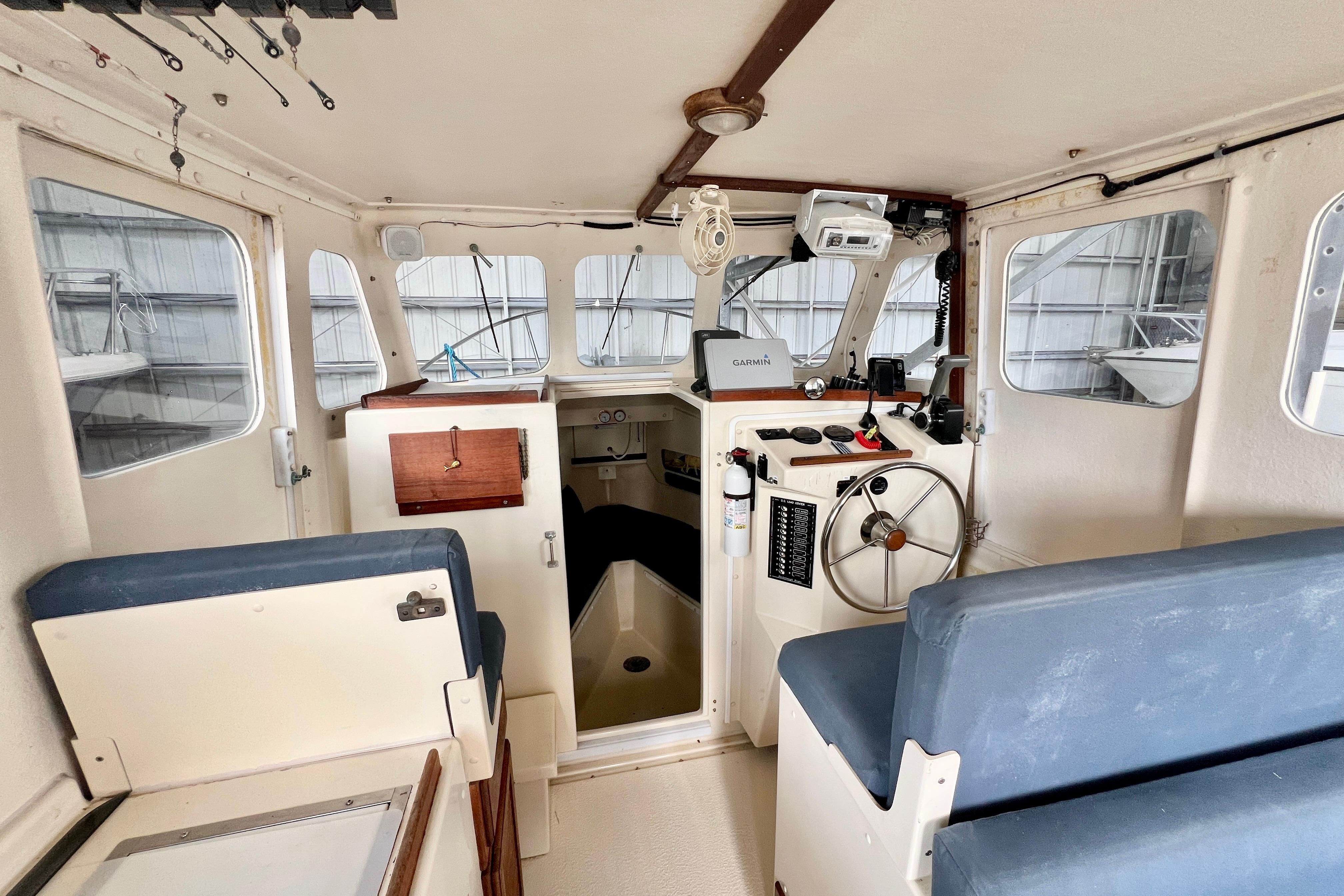 2001 Rosborough RF-246 Sedan Cruiser interior with helm, seating, and navigation equipment.