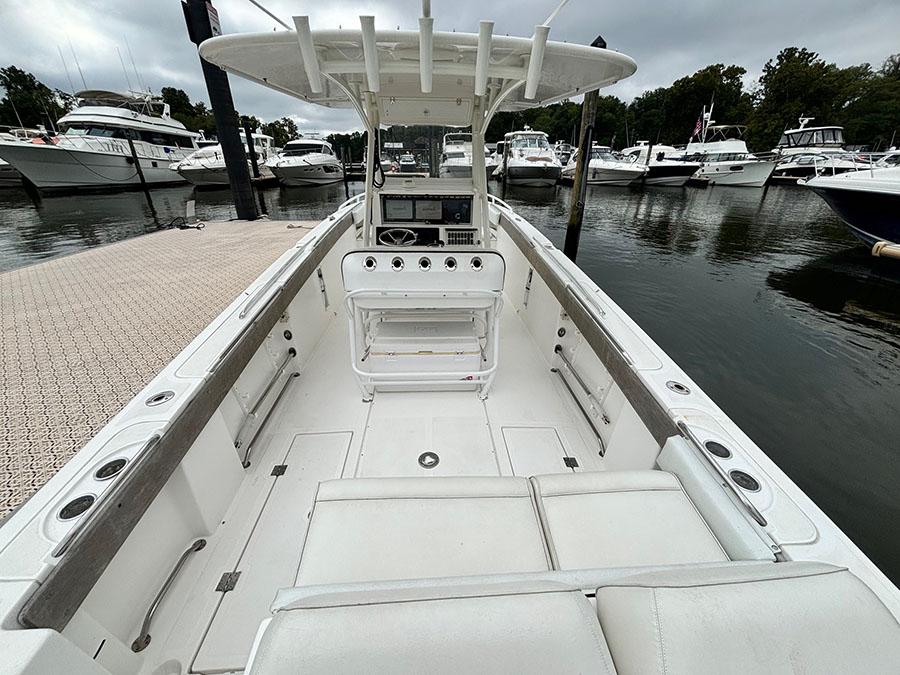 2003 Marlago FS35 boat docked at marina, featuring spacious deck and modern console.