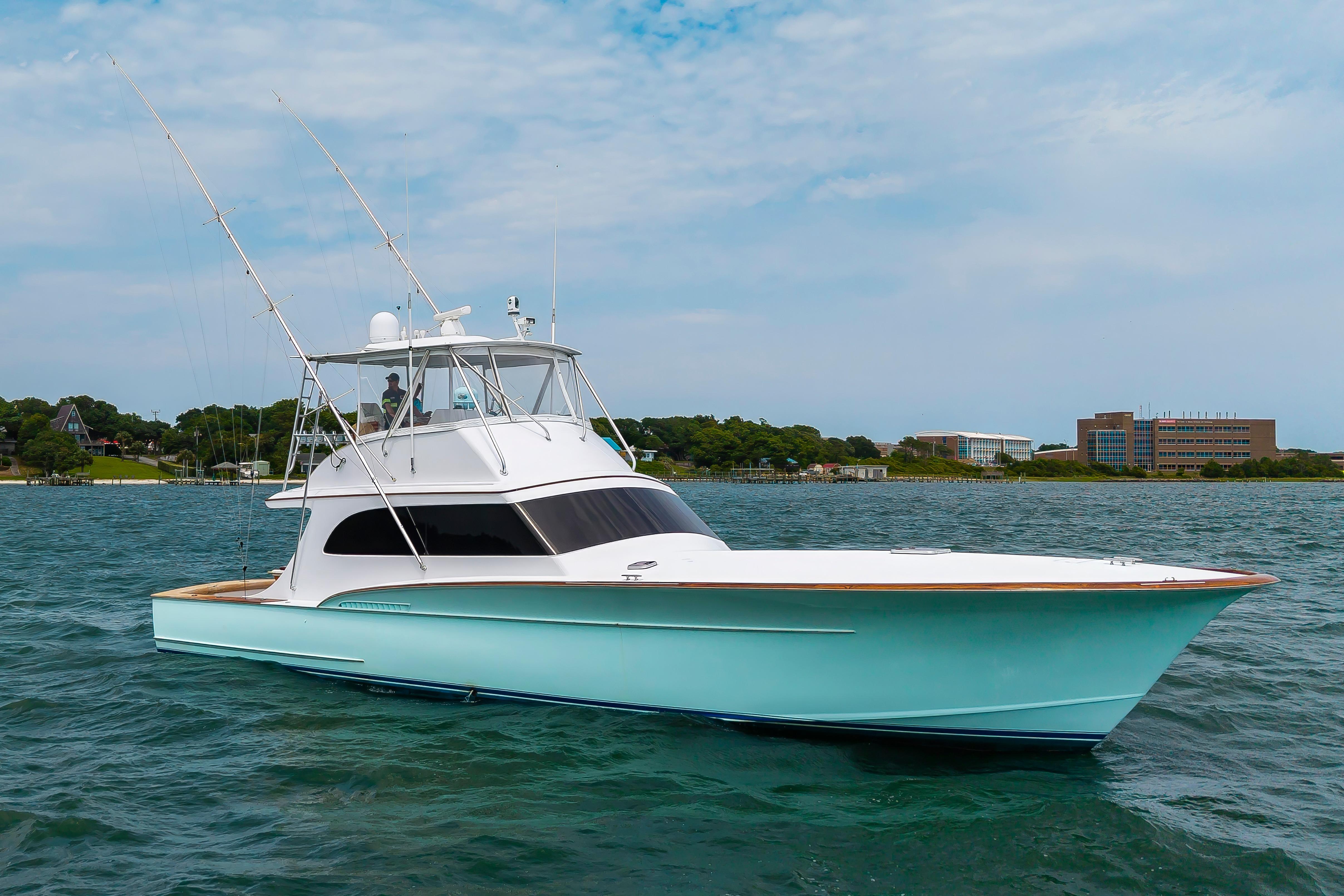 Custom Carolina Scarborough 56 Convertible yacht, 1993 model, cruising on a serene waterway.