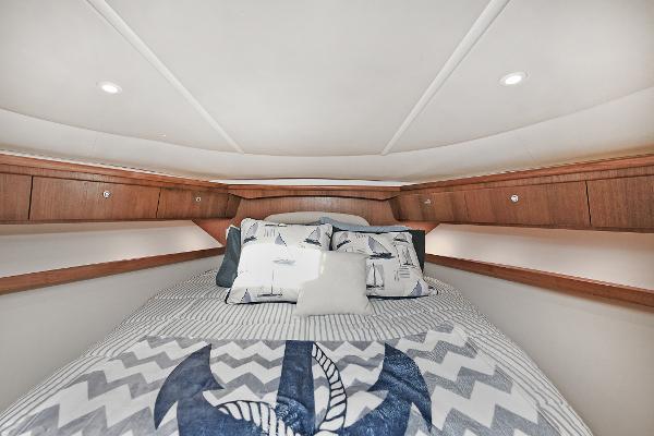 Luxurious cabin interior of 2008 Tiara Yachts 4200 Open with nautical-themed bedding.