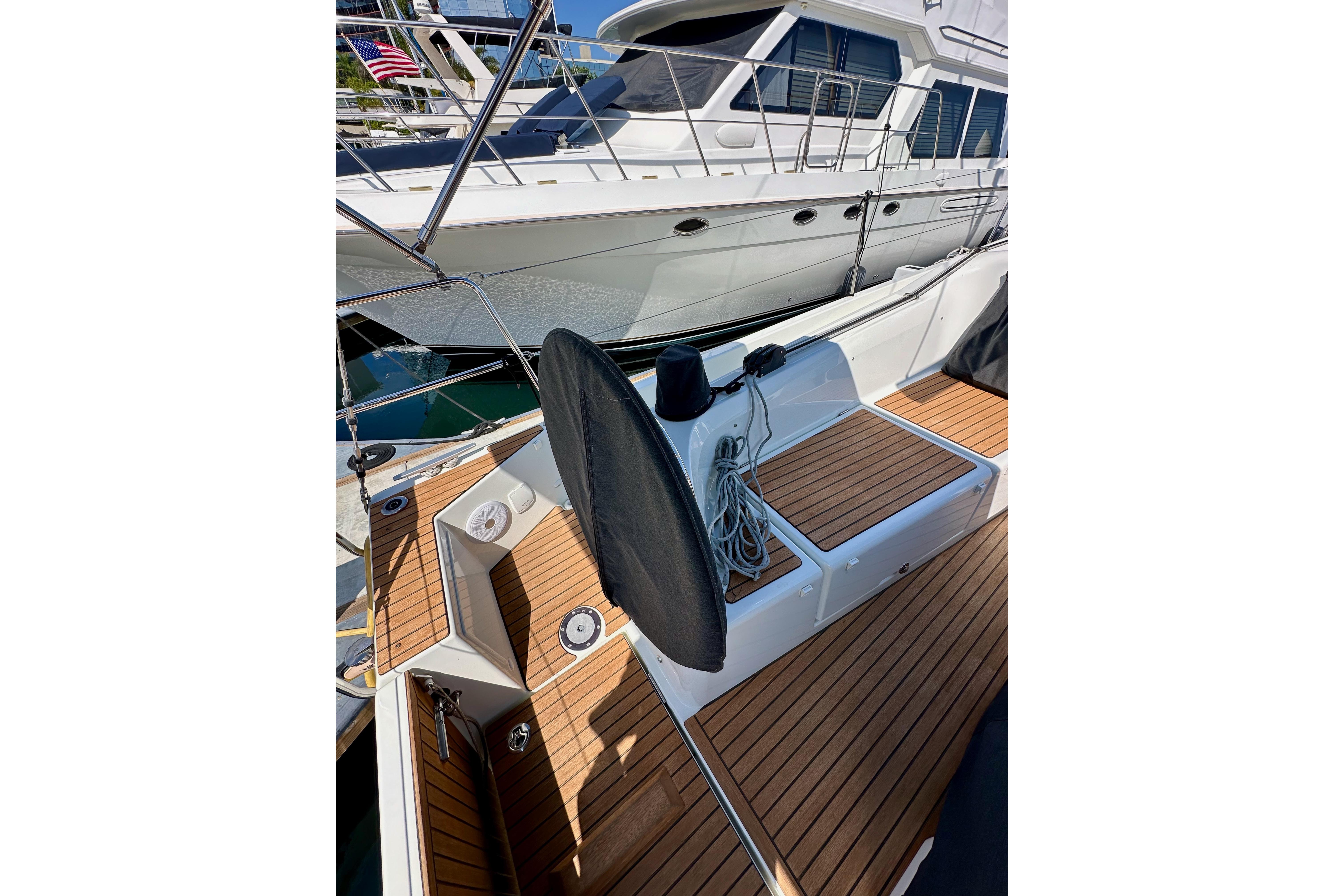 2024 Jeanneau Sun Odyssey 410 sailboat with teak deck and mooring lines.