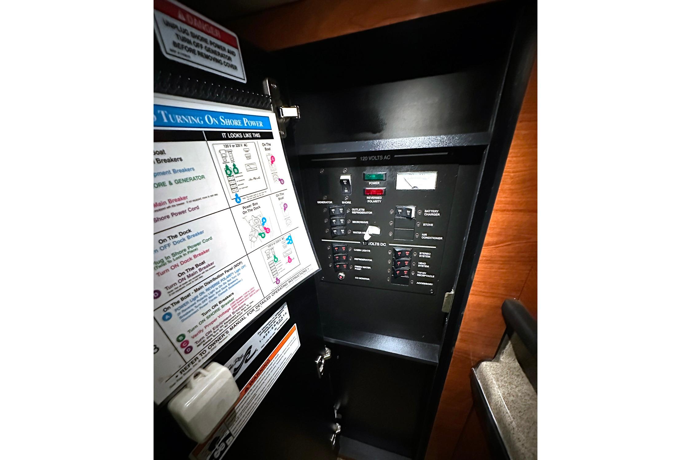 Electrical panel inside 2007 Sea Ray Sundancer 260 boat, featuring power controls and instructions.