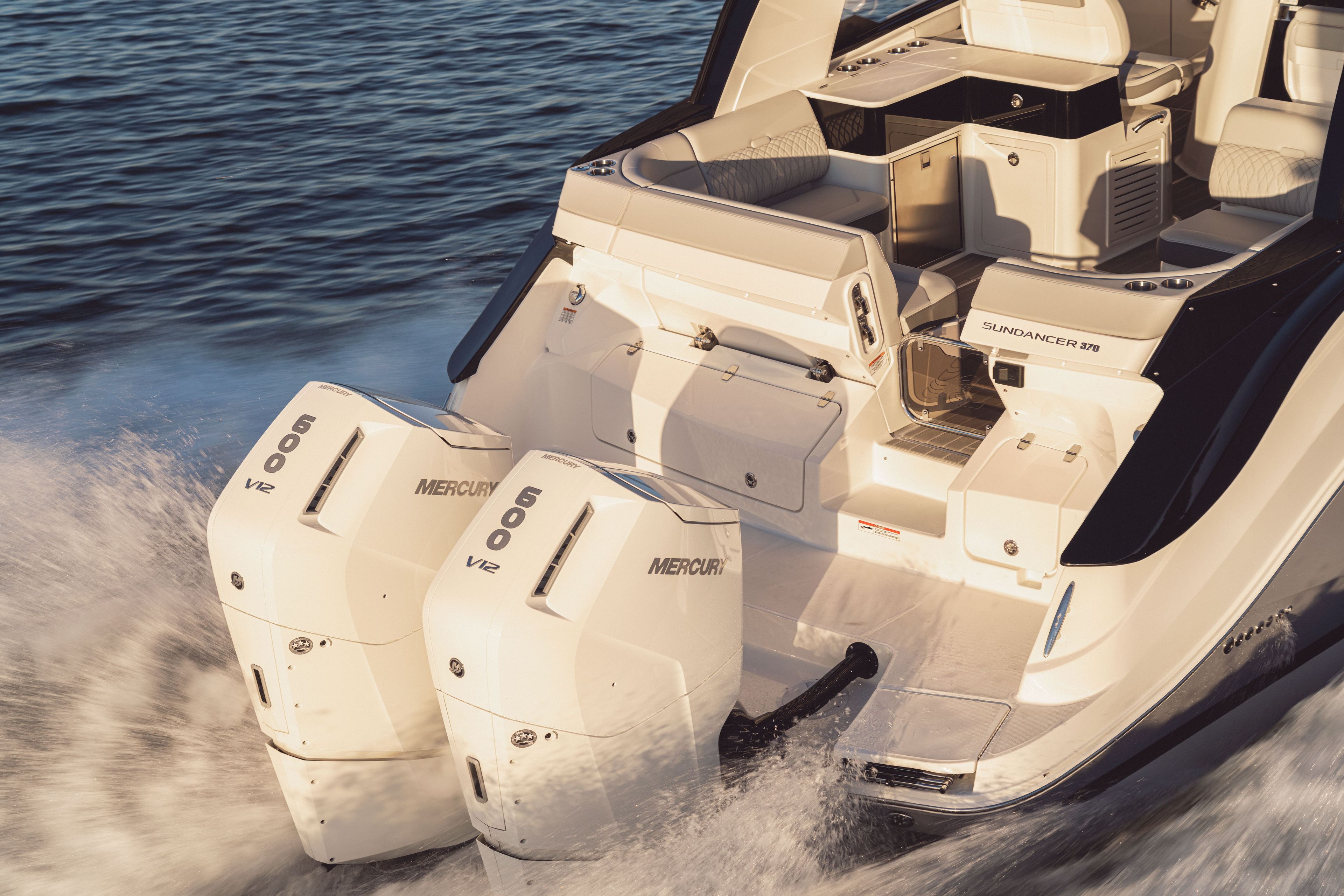 The image shows a Sea Ray Sundancer 370 Outboard boat with two Mercury engines on the water.