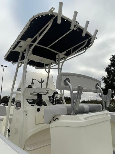 2024 Mako 214 CC center console boat with T-top and seating.