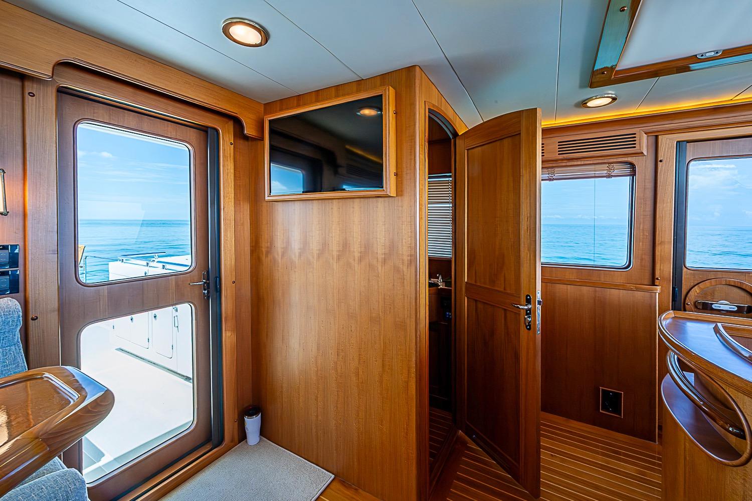 Interior of 2014 Marlow 80 Explorer yacht with wooden finishes and ocean view.