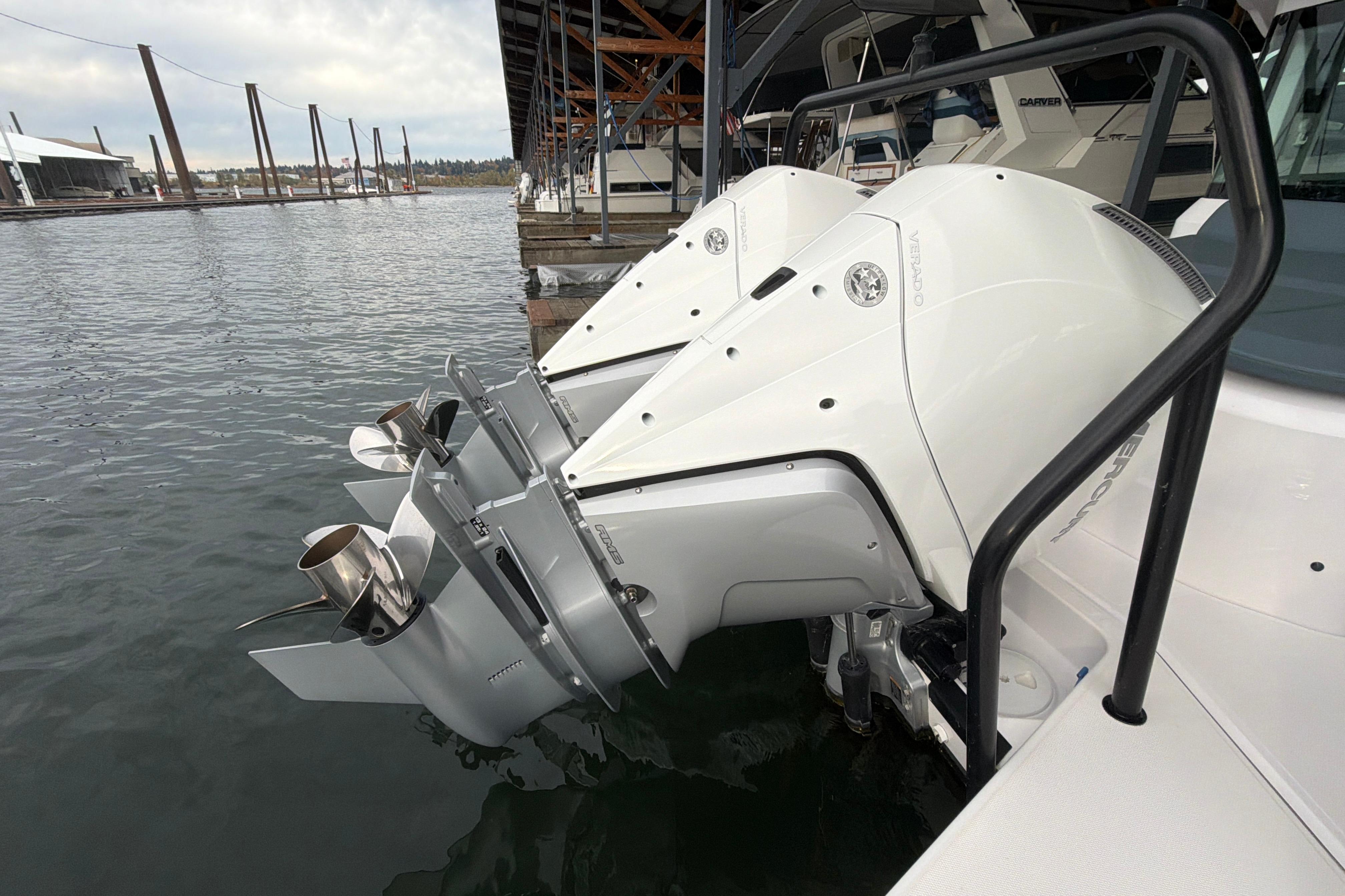 Twin outboard engines on a 2022 Axopar Brabus 37 XC Cross Cabin at a marina.