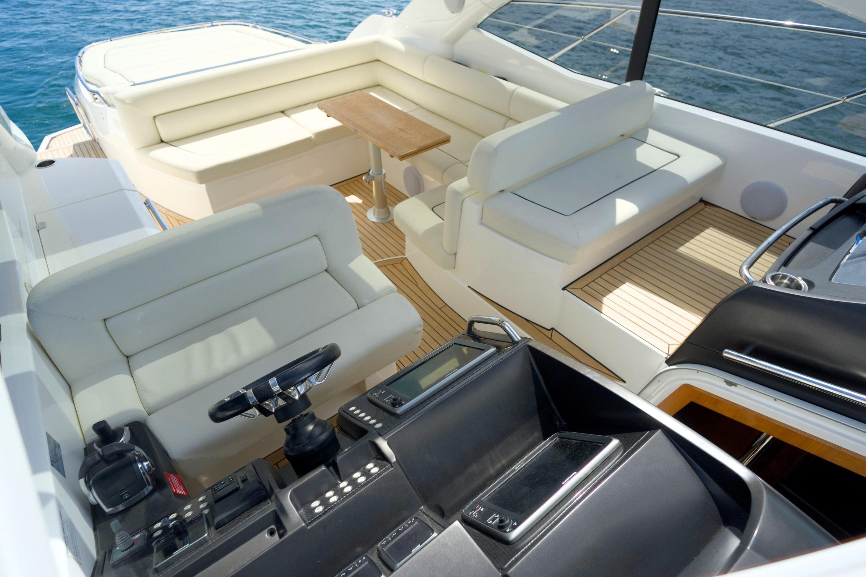 Luxurious Sunseeker San Remo 485 yacht interior, featuring elegant seating and a sleek helm.