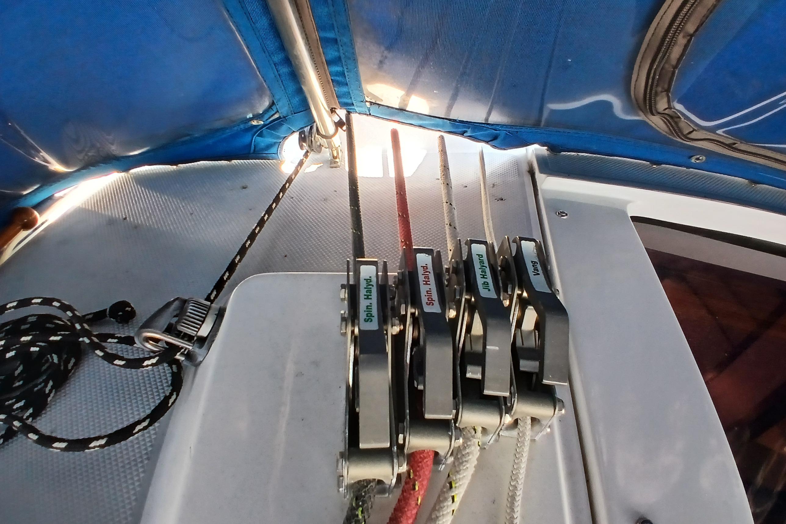 Sailing rigging controls on a 1995 Catalina 42 MkII yacht under a blue canopy.