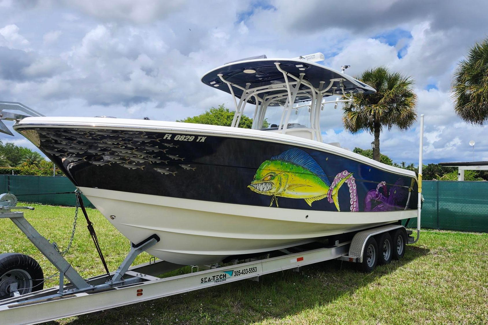 2015 Robalo R300 Center Console boat with vibrant marine artwork on trailer.