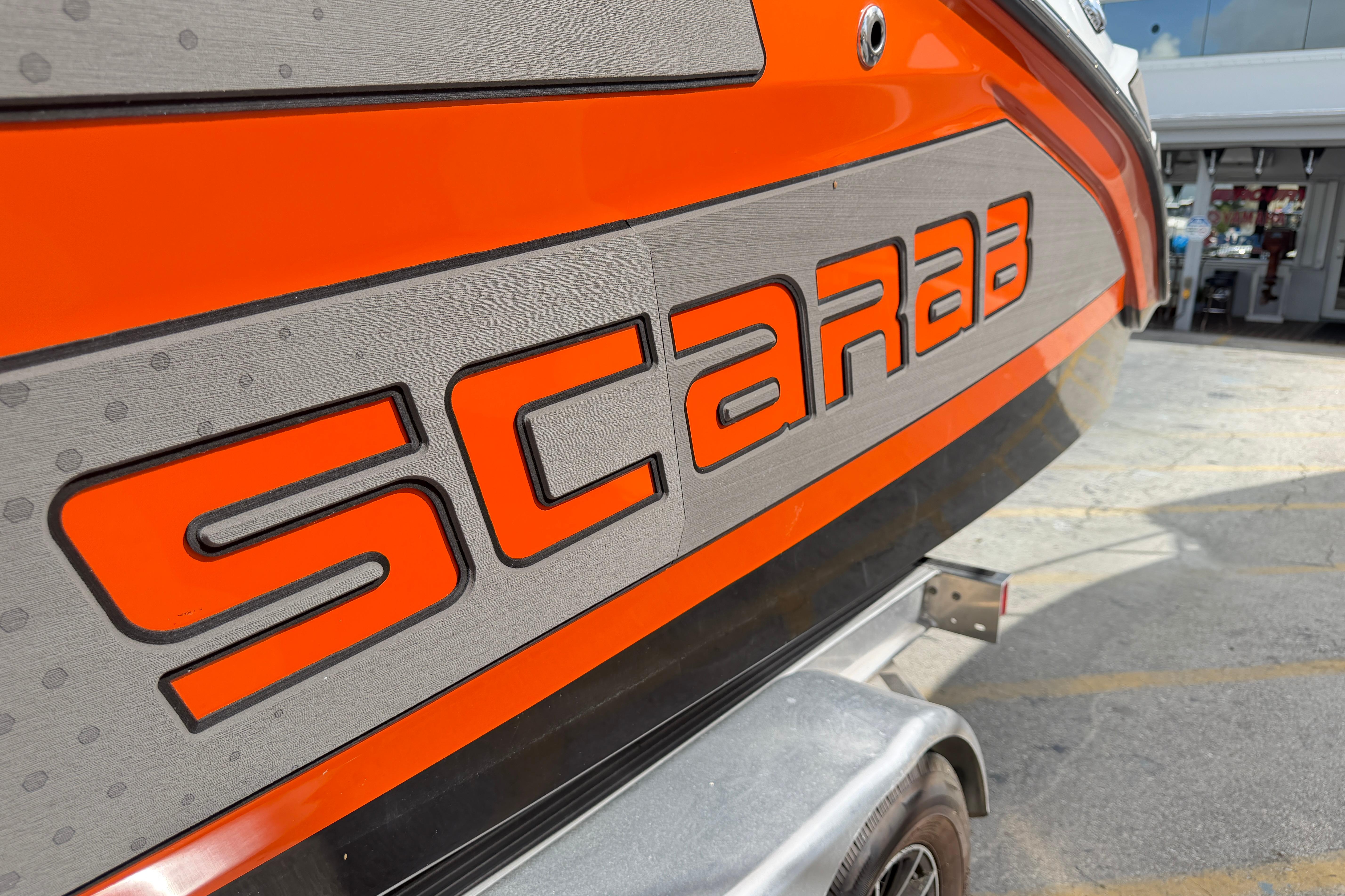 2026 Scarab 235 LX boat with bold orange branding on the side.