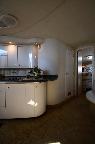 Interior of 1997 Sea Ray 400 Sundancer yacht with modern kitchen and cozy cabin.