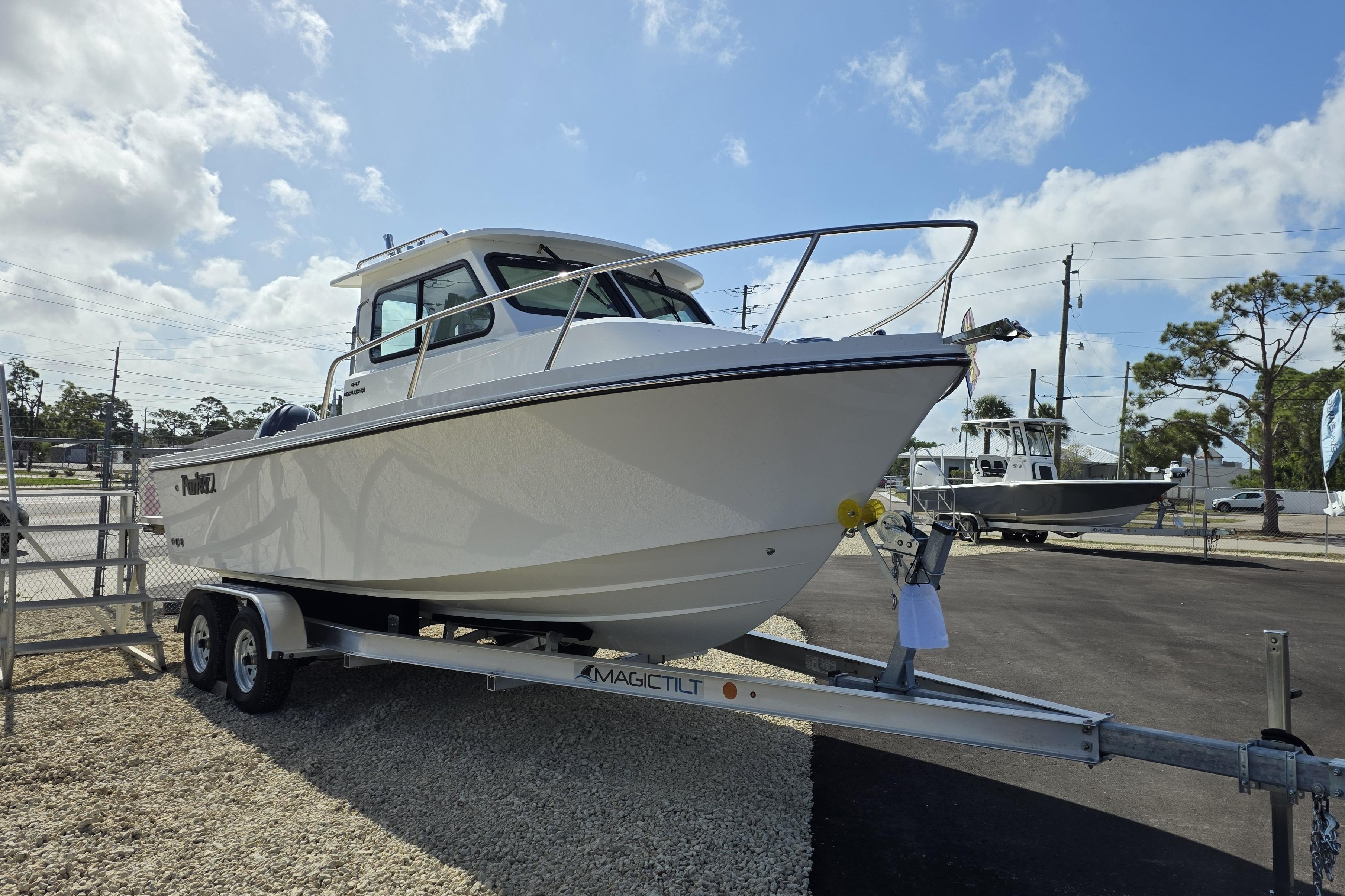 2026 Parker 227 Explorer boat on trailer under clear sky.