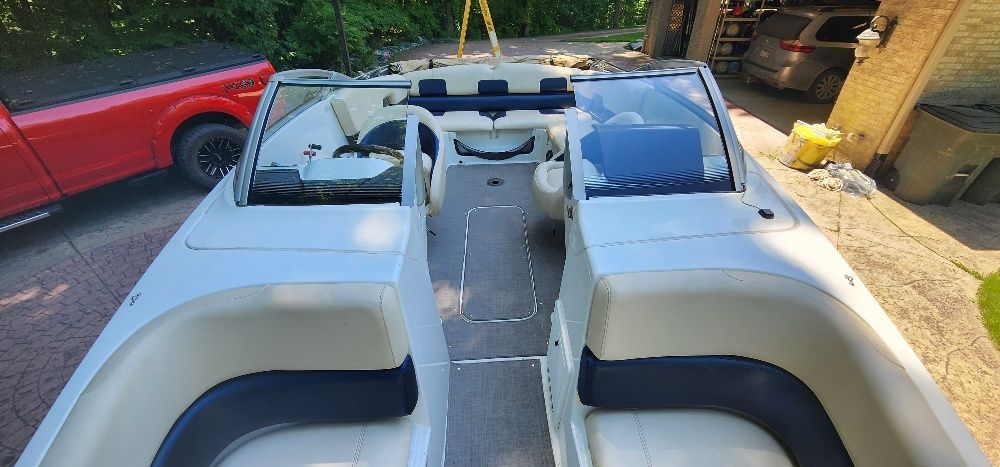 The image shows a 2007 Sea-Doo Sport Boat, model 230 Challenger SE, with white and blue seating.