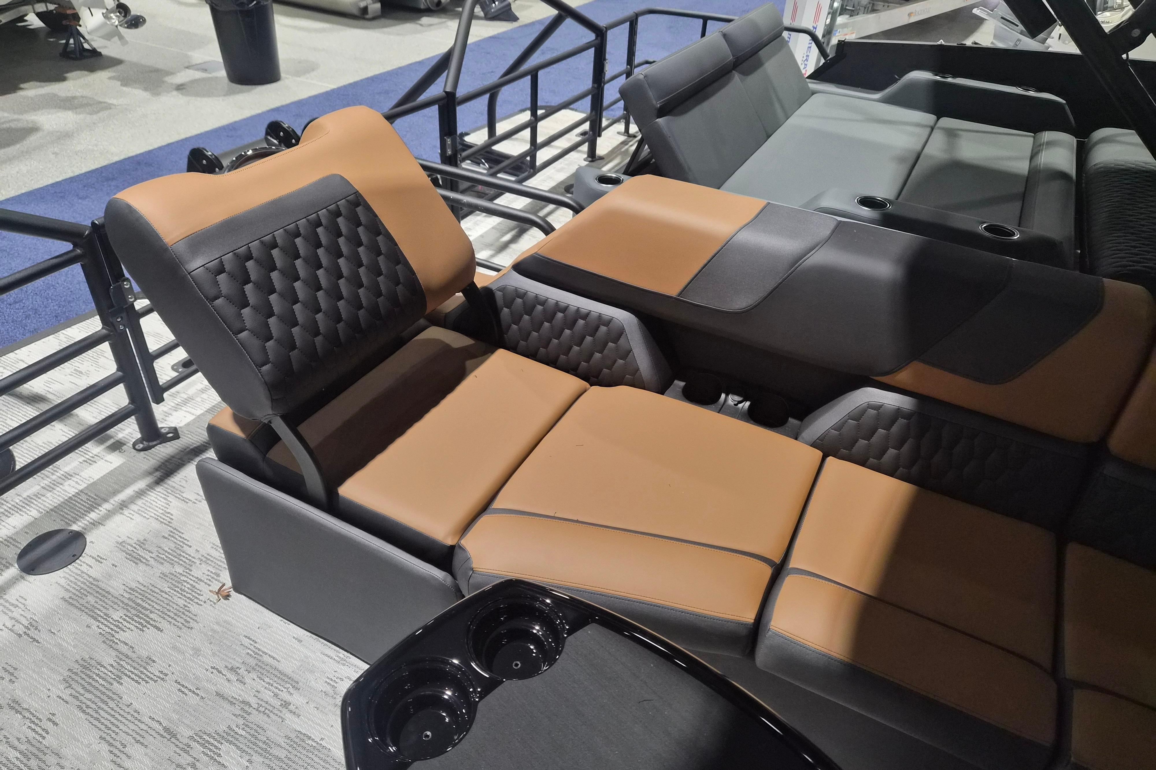 Luxurious seating in 2026 Sylvan L3 SLZ boat, featuring brown and black upholstery.