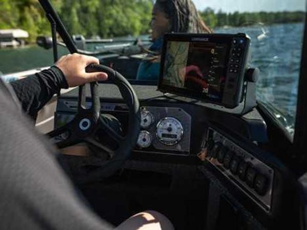 2026 Lund 2075 IMPACT XS boat dashboard with navigation system on a sunny day.