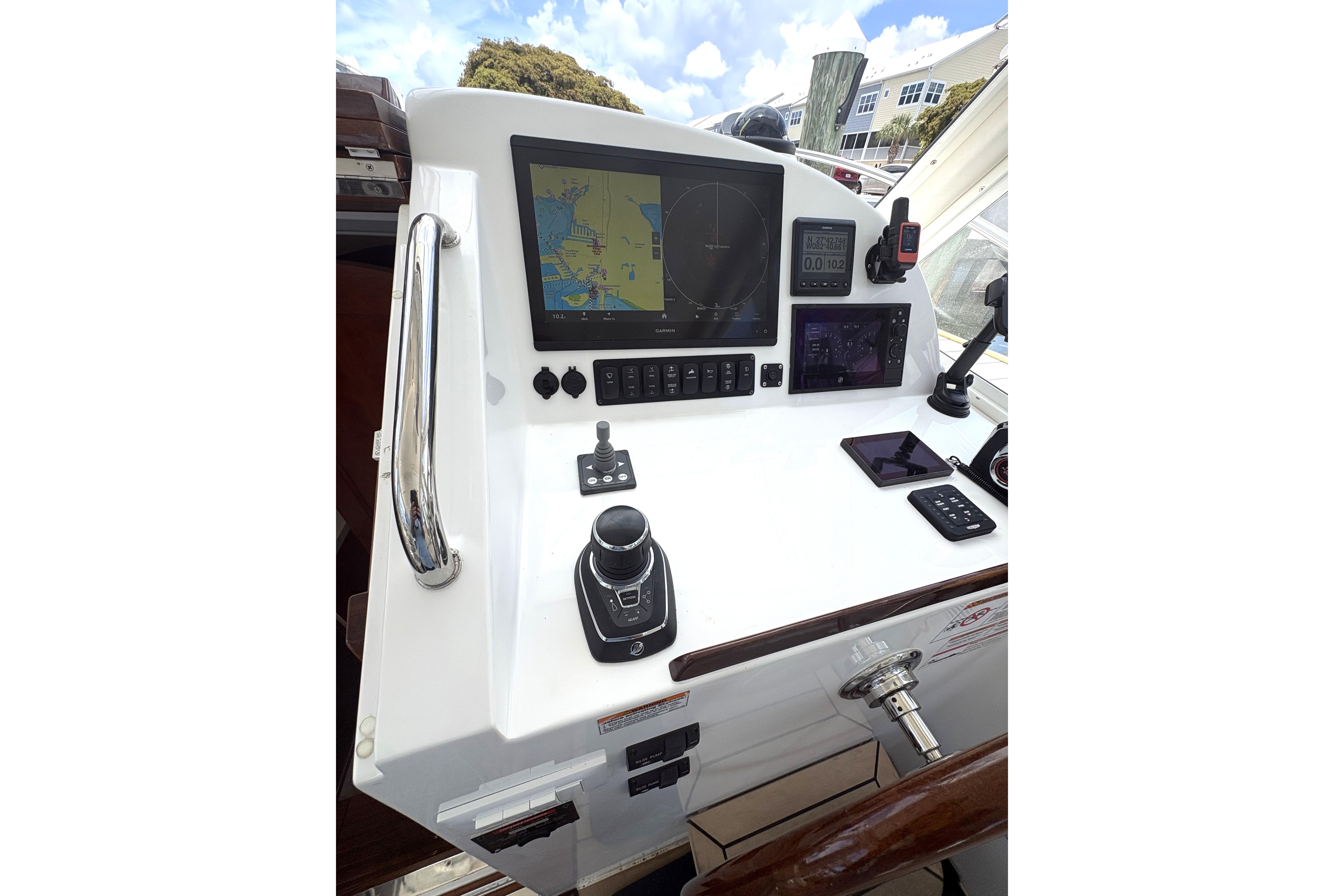 Control panel of 2024 MJM 35z boat featuring navigation and communication equipment.