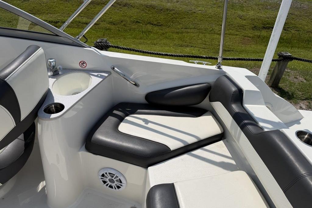 2019 Stingray 201 DS boat interior with black and white seating, cup holders, and sink.
