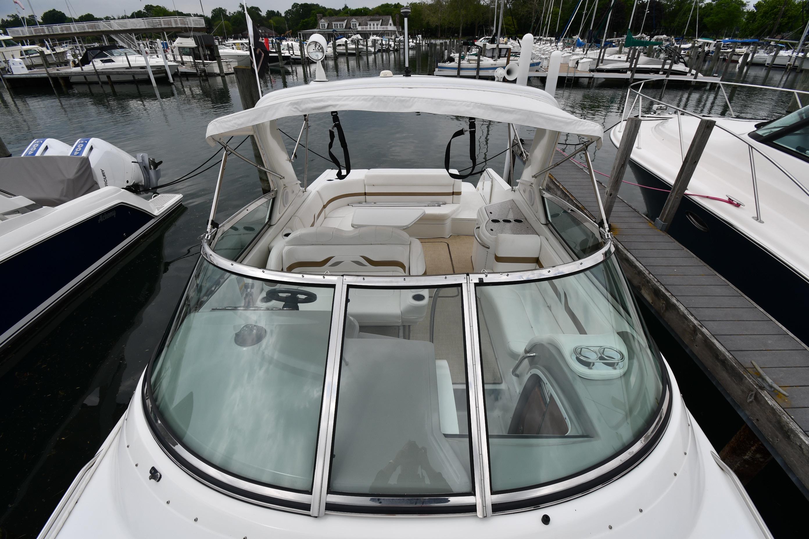 2004 Formula 330 Sun Sport boat docked at a marina, featuring a sleek design and spacious seating.