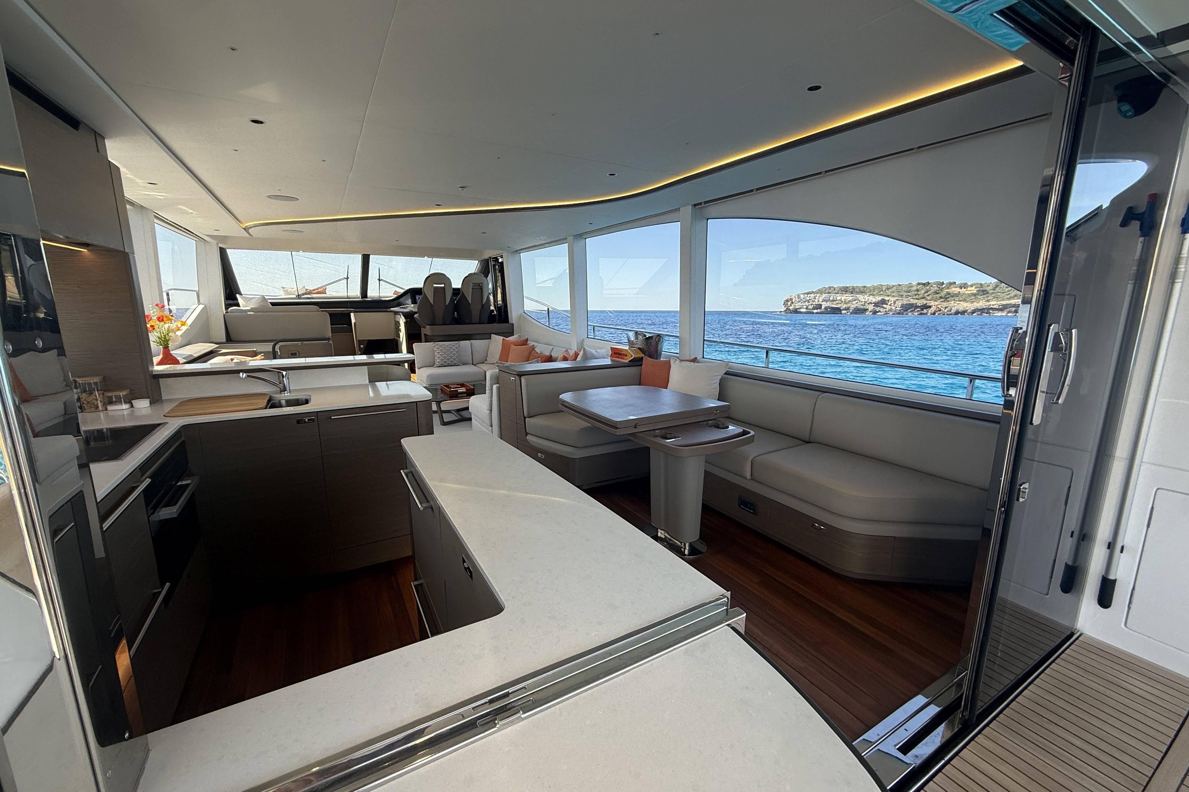 Luxurious interior of 2025 Princess Y72 yacht with modern kitchen and seating area.