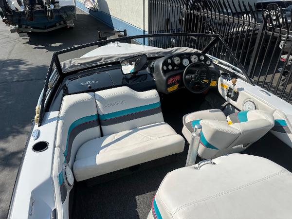 1992 Correct Craft Ski Nautique boat interior with white and teal seating, dashboard, and steering wheel.