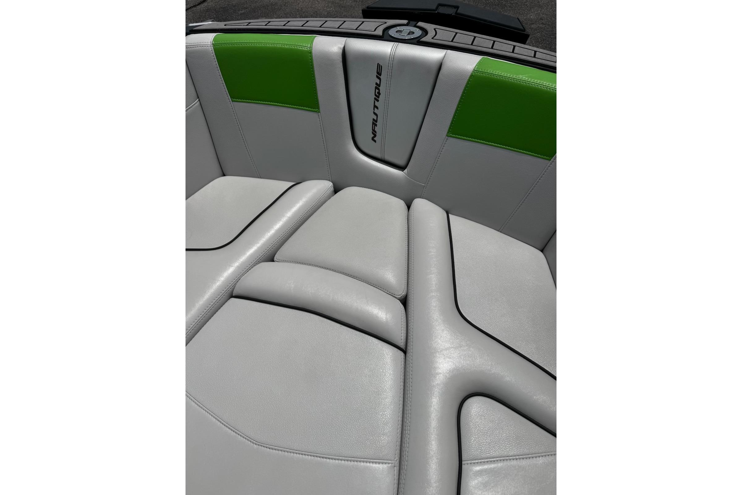 2014 Nautique Super Air Nautique G21 boat interior with gray and green upholstery.
