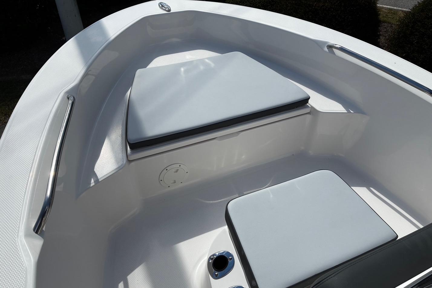 2026 Robalo R160 Center Console boat seating area with cushioned seats and stainless steel handrails.